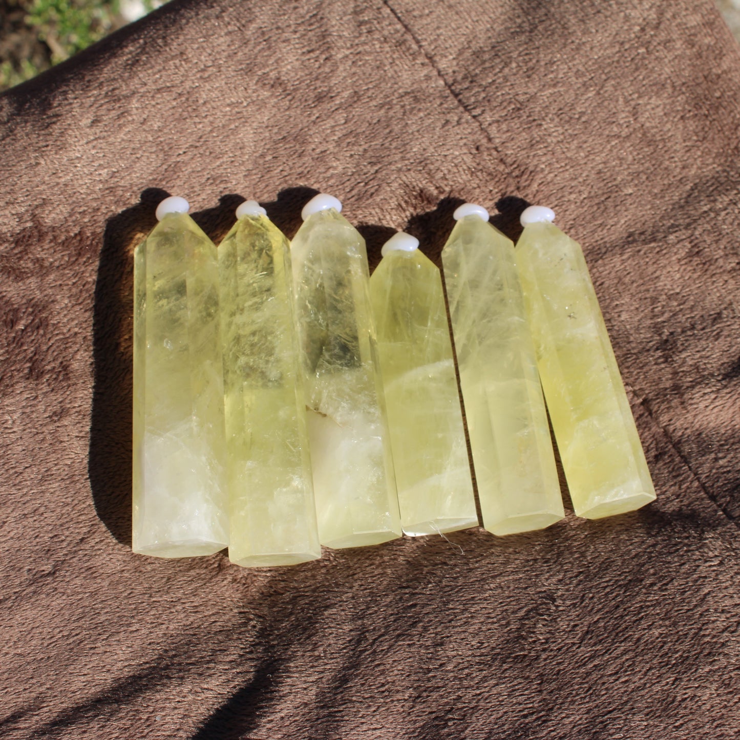 Set of seven Lemon Quartz Towers with natural crystal clarity and vibrant yellow hue