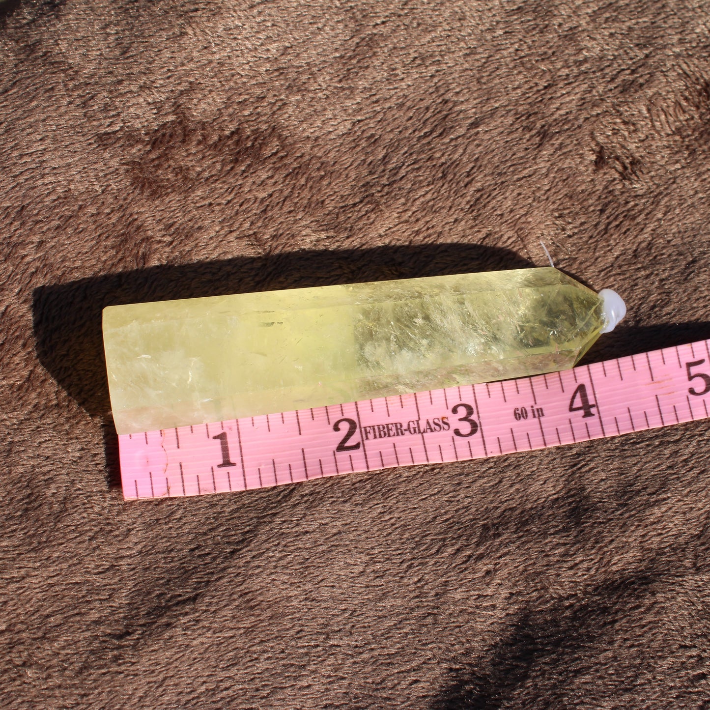 Lemon Quartz Tower crystal in a vibrant yellow color, measuring approximately 4 inches long