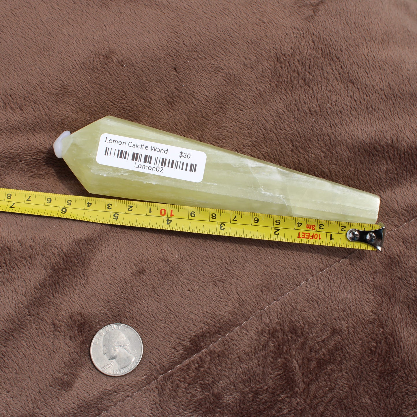 Lemon Quartz Wand crystal measuring about 6 inches with a price label from Different Branches LLC