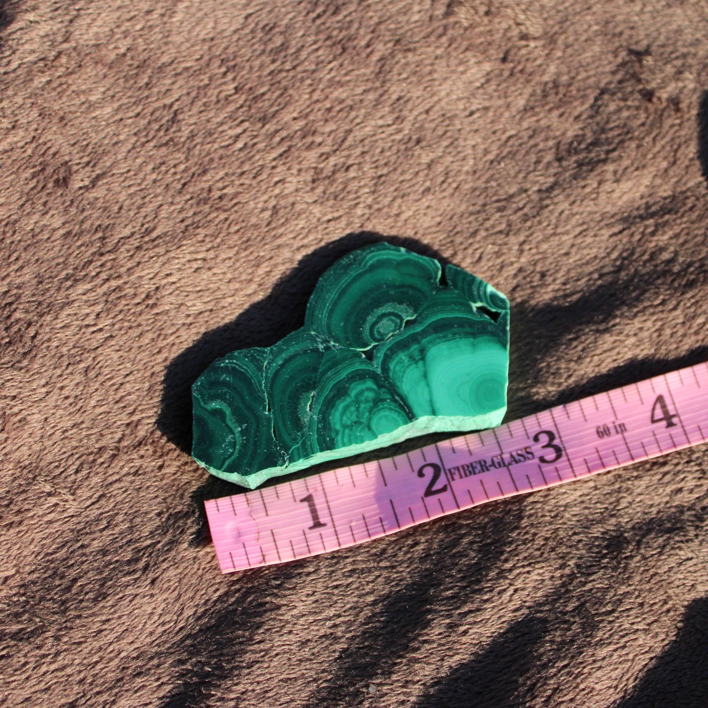 Natural Malachite slab showcasing rich green patterns perfect for home decor or healing purposes