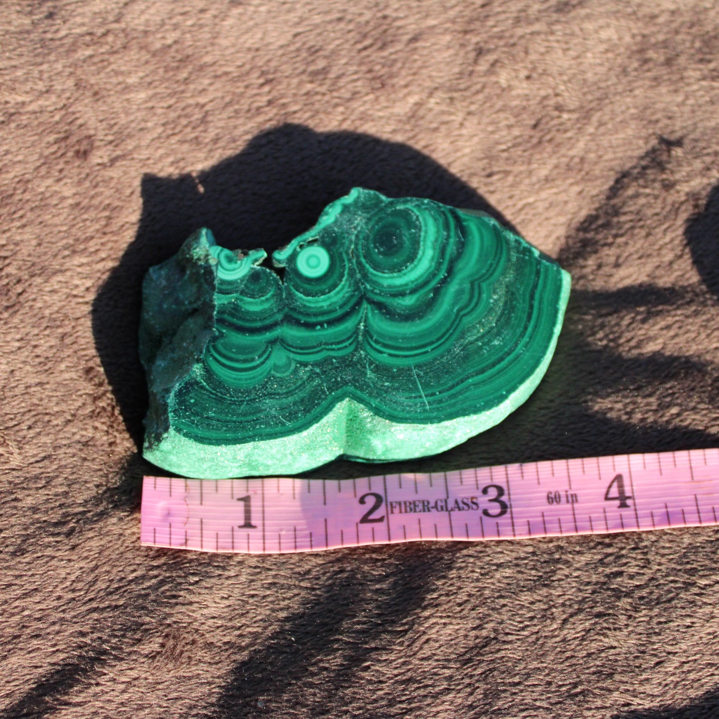 Natural Malachite slab with vibrant green bands, perfect for decor or collection