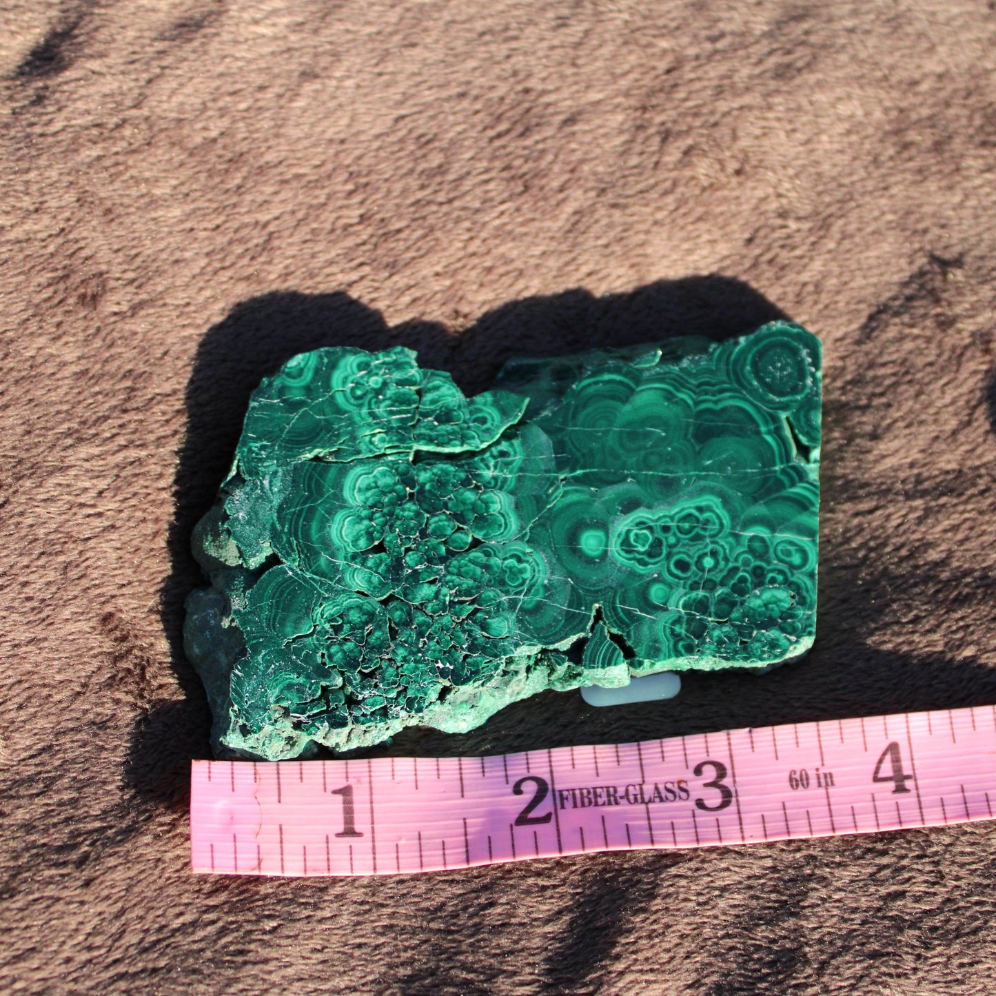 Natural Malachite slab with unique banding patterns for home decor and crystal enthusiasts