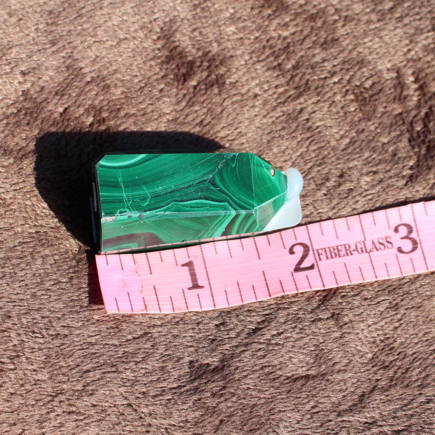 Malachite tower collection showcasing a vibrant green crystal with unique natural patterns