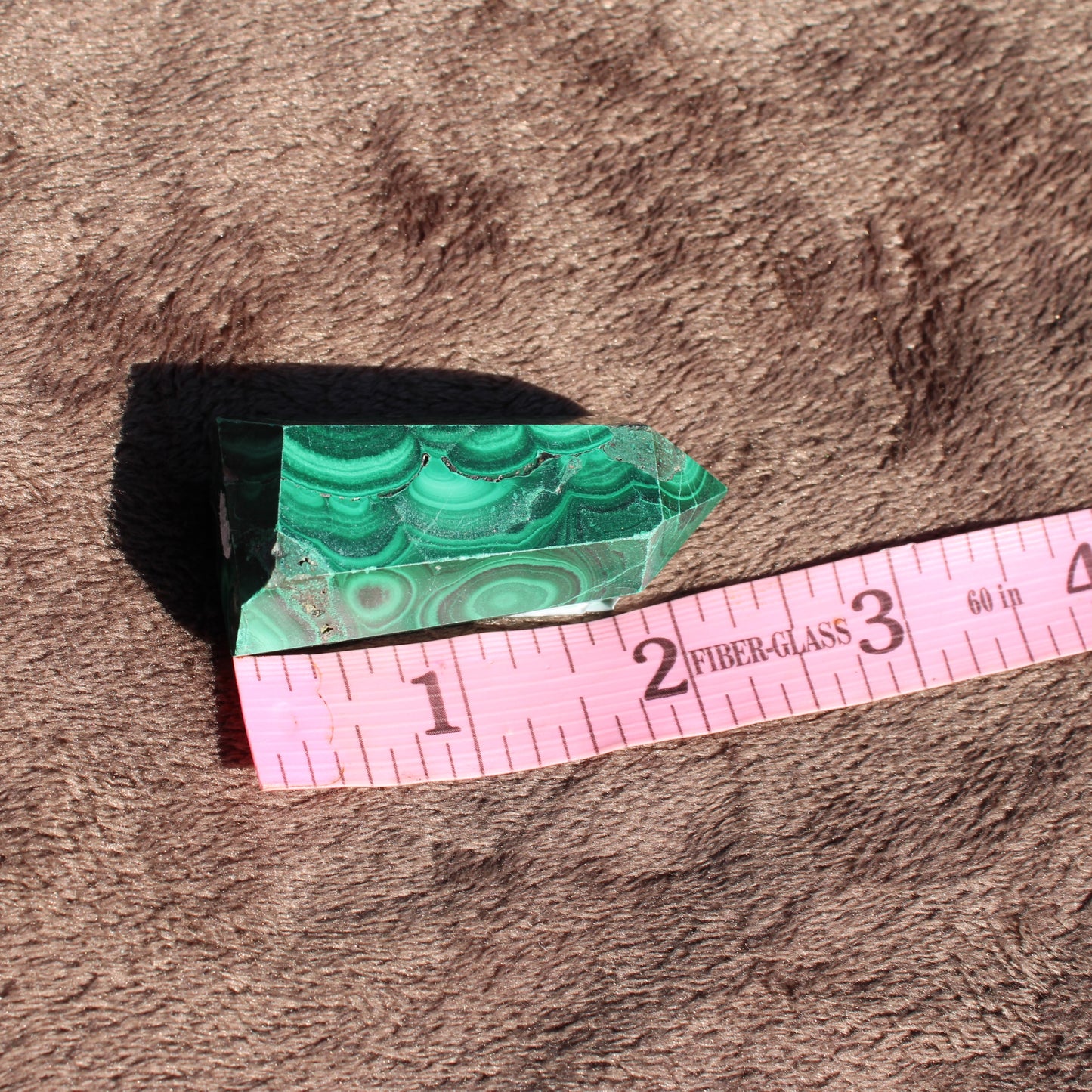 Natural Malachite tower collection piece showcasing stunning green patterns and crystal clarity