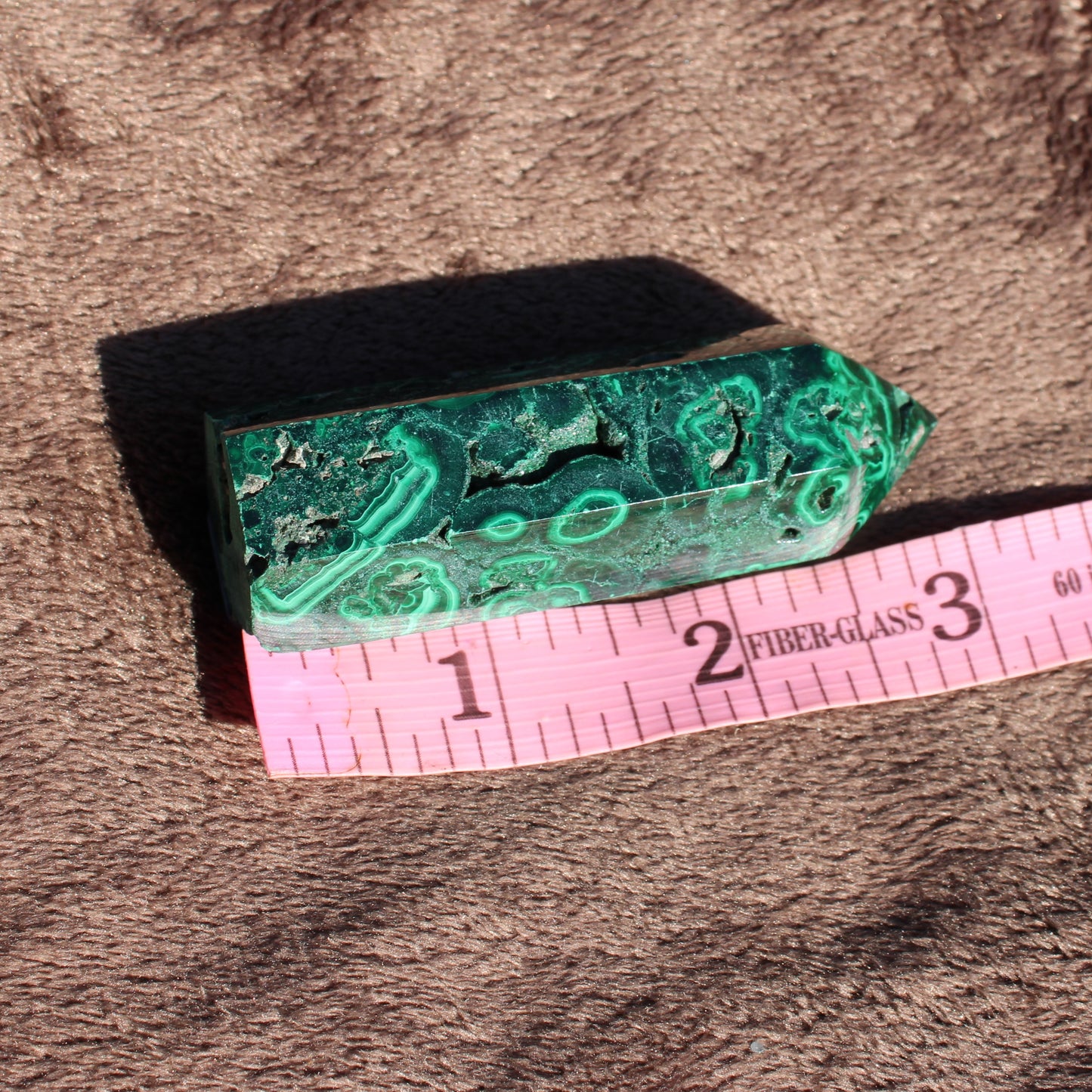 Malachite tower collection featuring a polished green crystal with natural patterns and an elegant finish