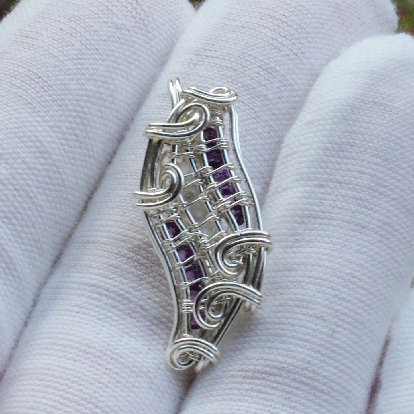 Moonstone, Amethyst, Sterling silver Pendant with intricate wire design displayed on a white glove