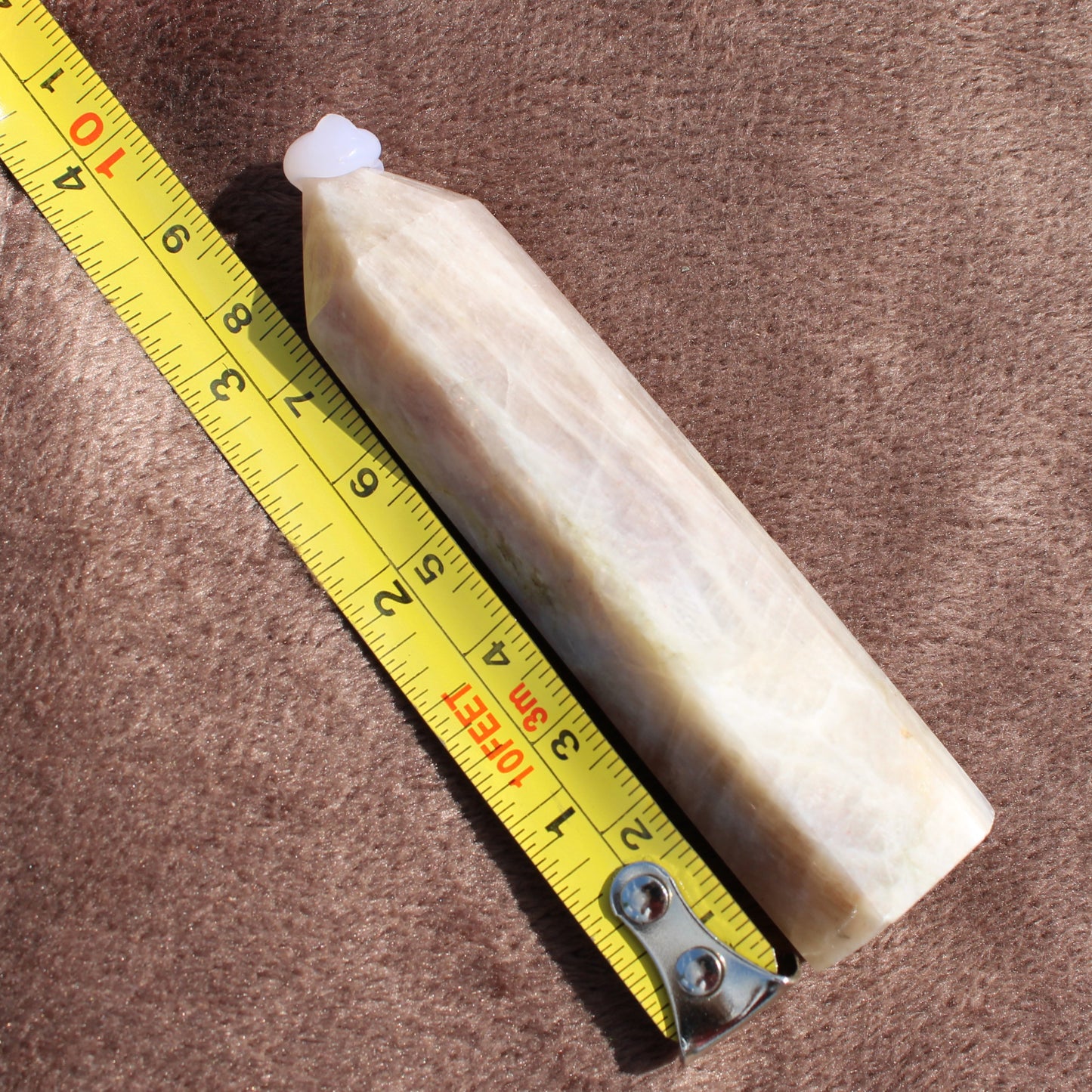 Moonstone Tower crystal measuring about 7 inches with beige and white hues from Different Branches LLC