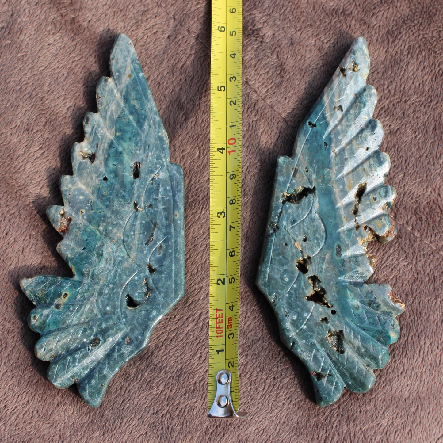 Pair of Ocean Jasper Owl Wings crystals by Different Branches LLC with measuring tape for size reference
