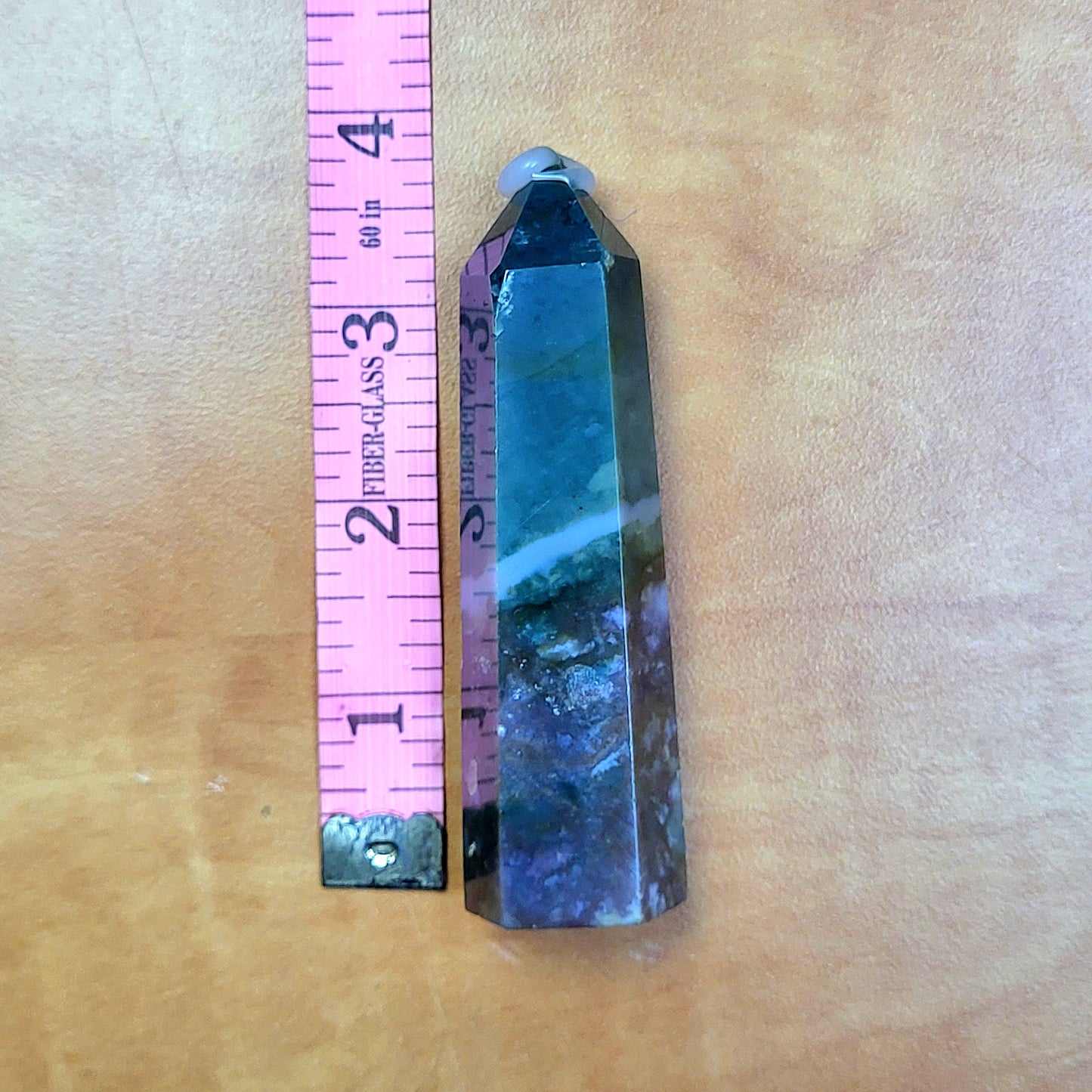 Ocean jasper tower featuring unique patterns and colors, measuring approximately three inches in height