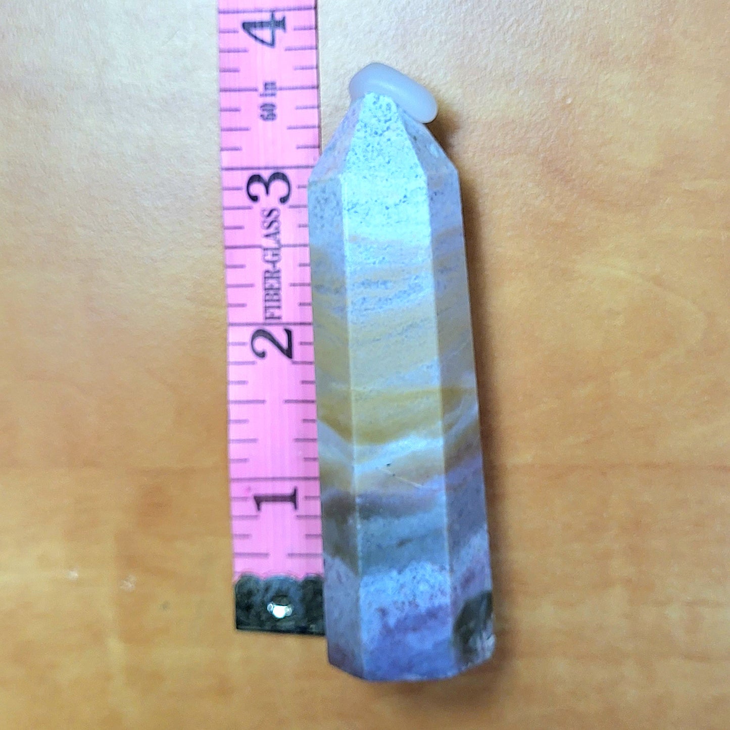 Ocean jasper tower with unique colors and patterns, measuring two inches tall for home decor