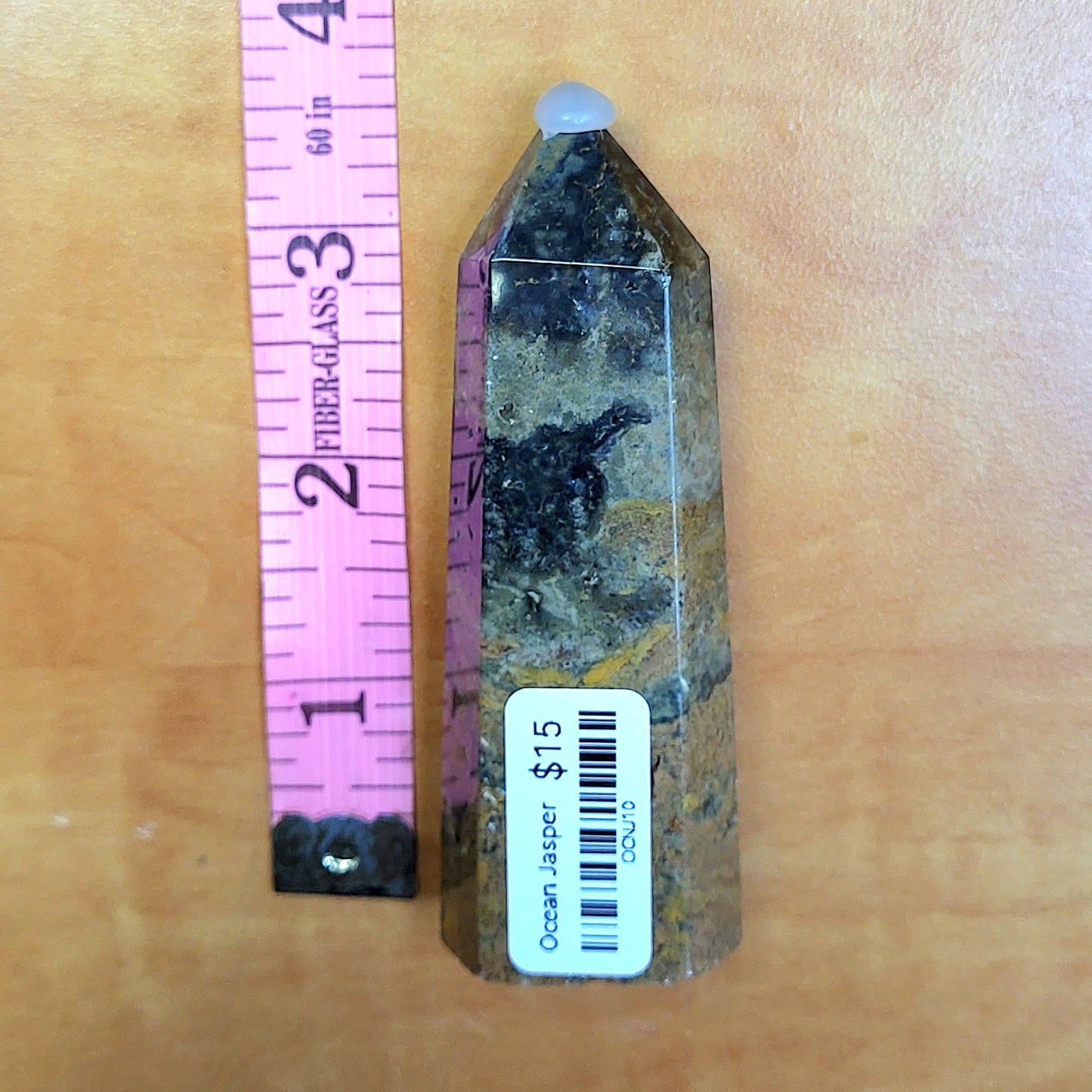 Ocean jasper tower with unique patterns displayed next to a ruler for size reference