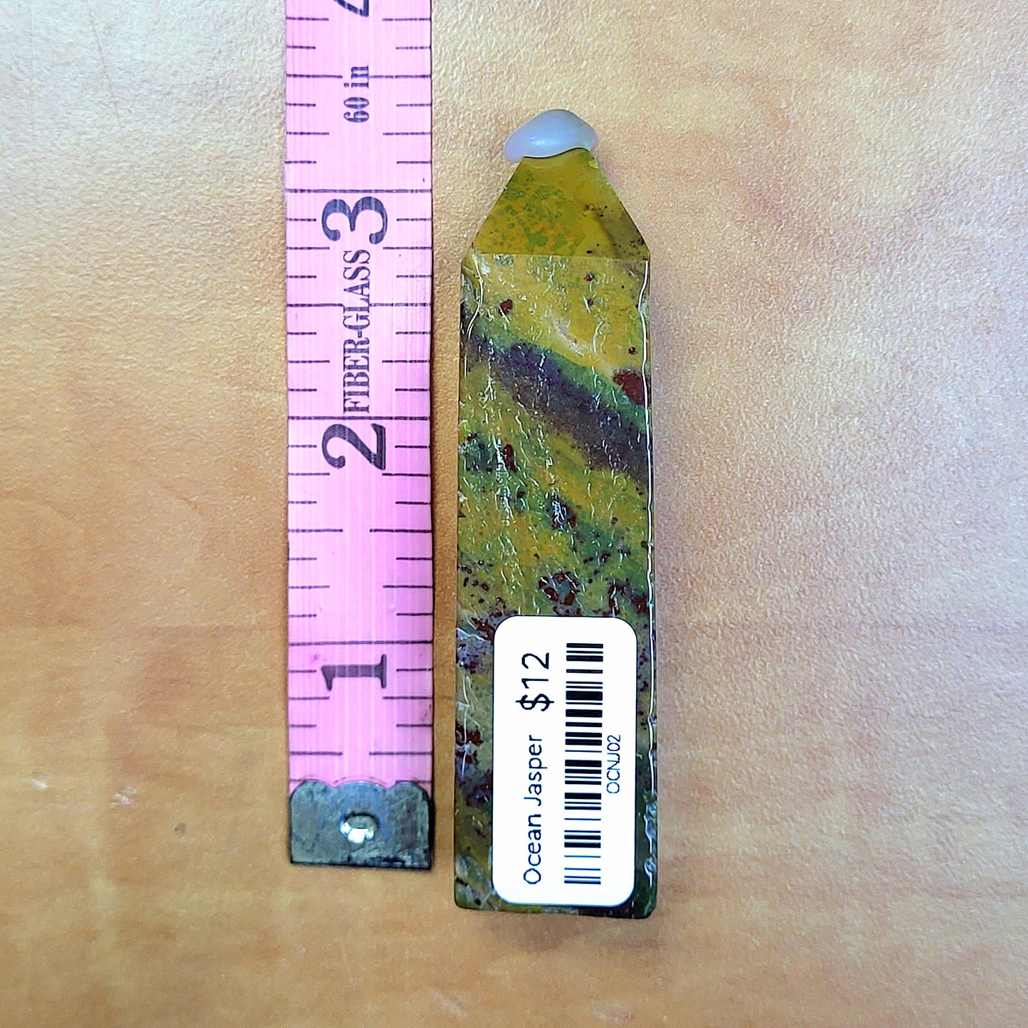Ocean Jasper tower displayed next to a ruler for size comparison, showcasing unique color patterns