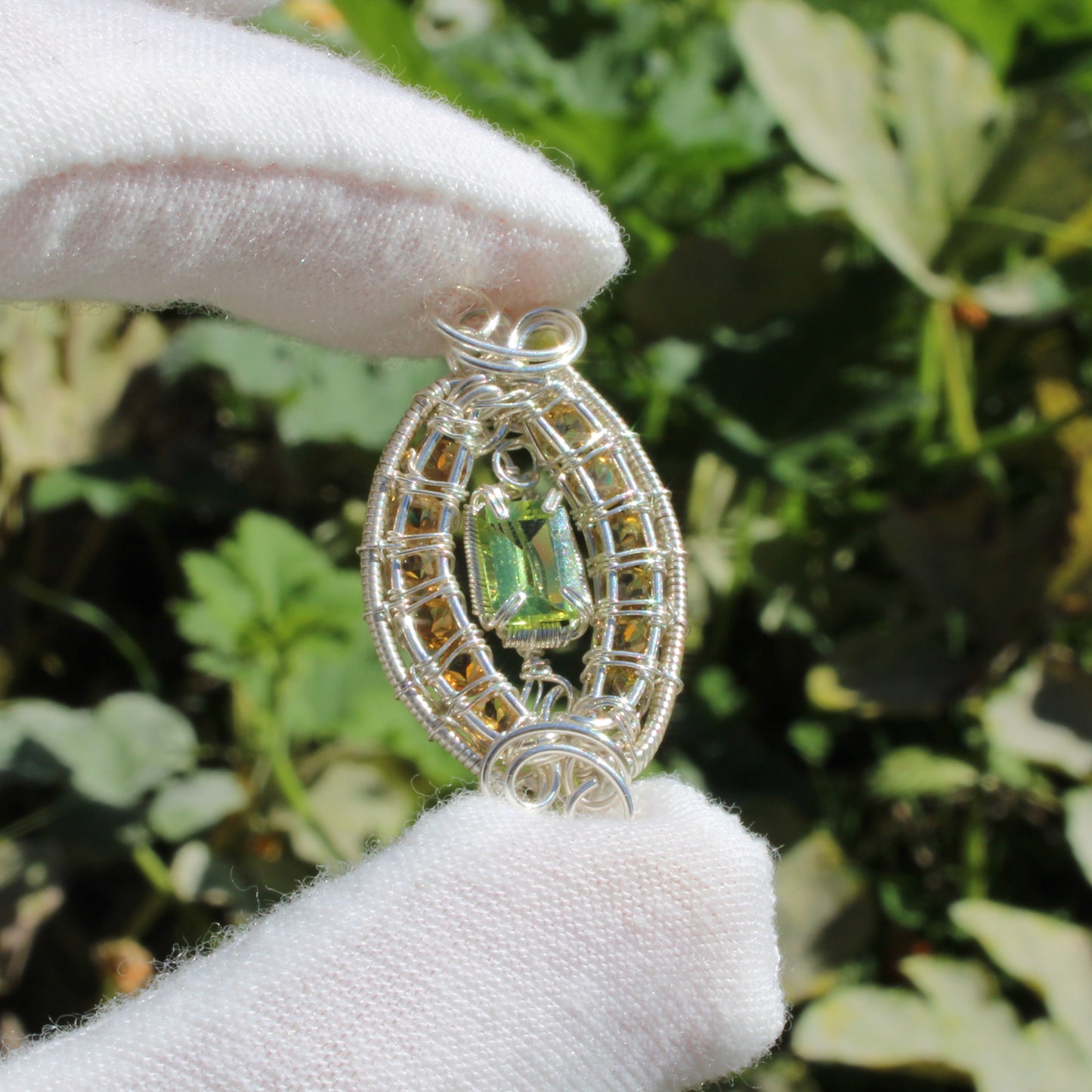 Peridot Sterling Silver yellow tourmaline pendant with intricate wire design, elegantly displayed