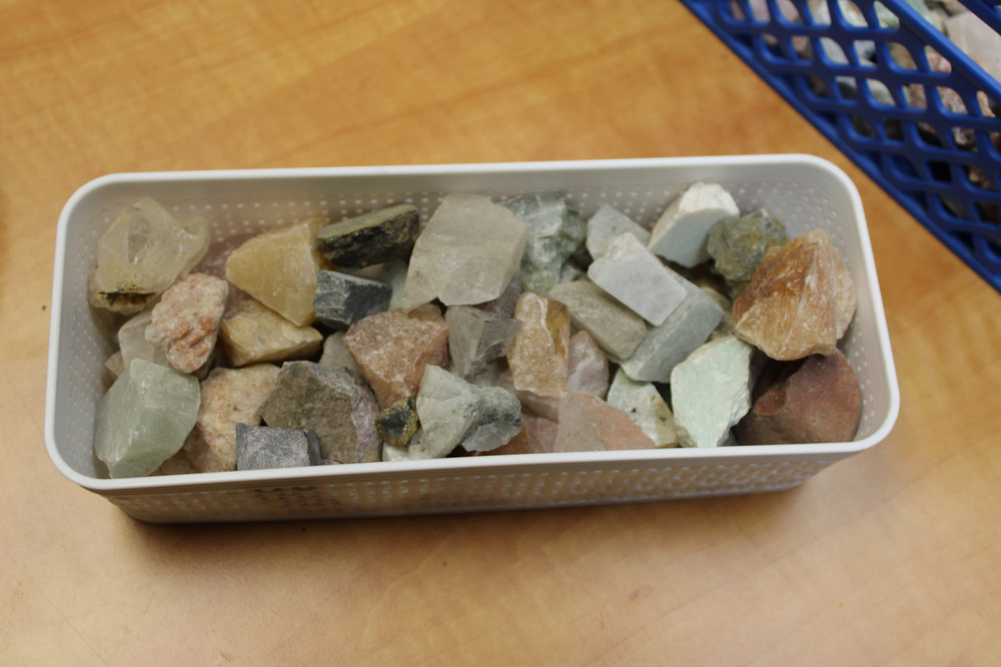 Different Branches LLC large gem mining mystery bag of assorted rough crystals in white tray on table