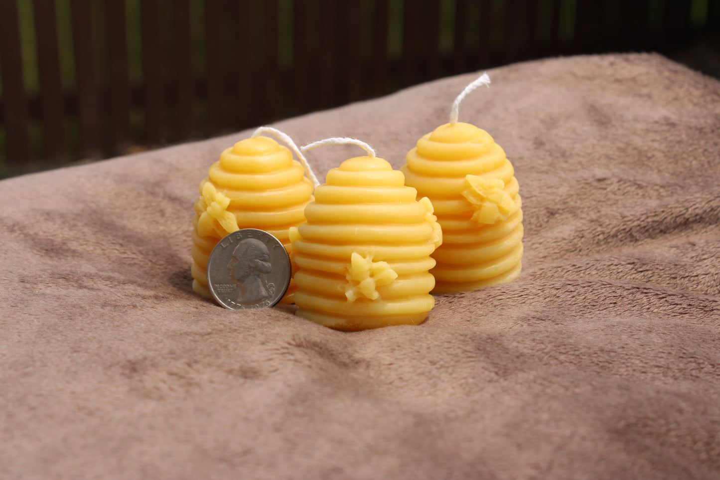 Three decorative pure beeswax candles shaped like beehives at a pure beeswax candle shop