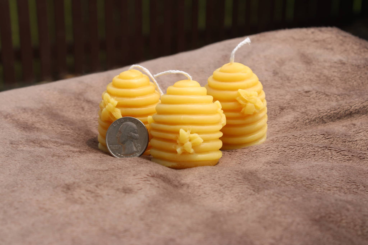 Three decorative pure beeswax candles shaped like beehives at a pure beeswax candle shop