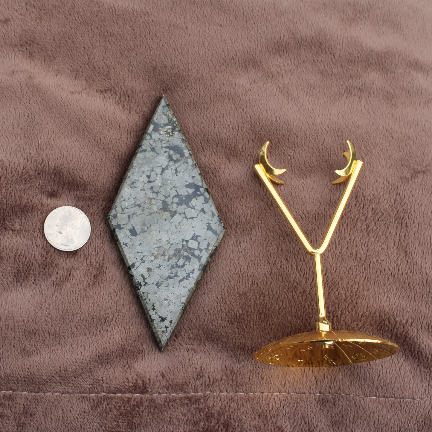 Pyrite Diamond crystal from Different Branches LLC displayed with a gold crescent moon stand and a coin for size reference