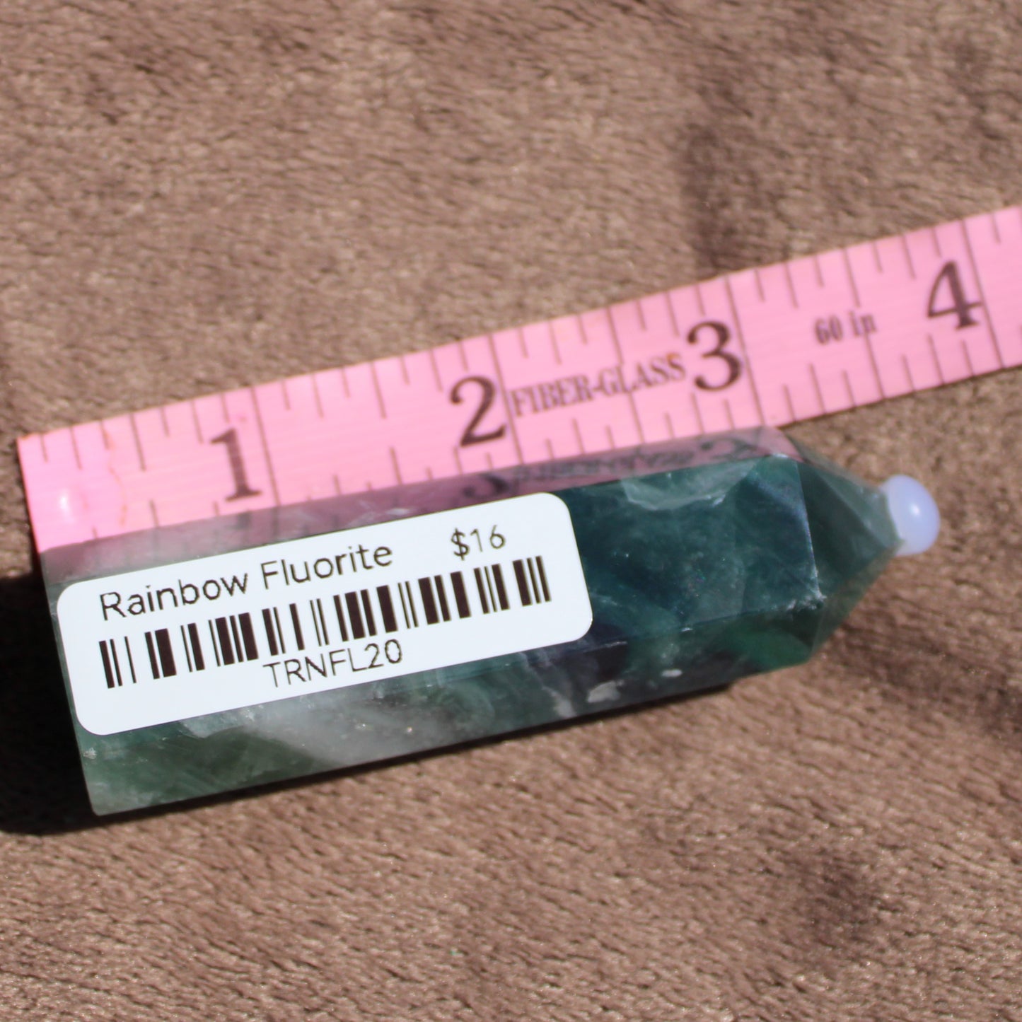Rainbow Fluorite tower displaying vibrant green and purple hues, perfect for crystal collectors and décor