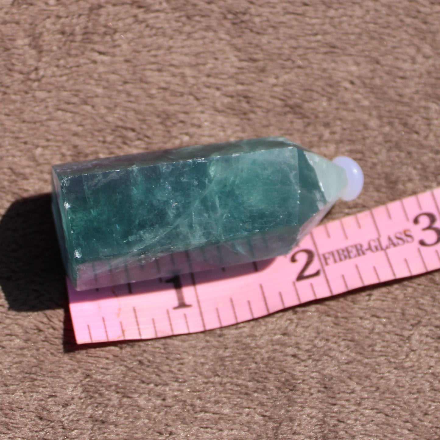 Rainbow Fluorite tower with smooth surface and pointed top, ideal for crystal healing and decoration