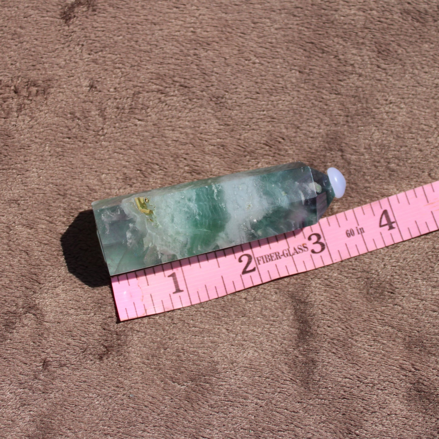 Rainbow Fluorite tower showcasing vibrant green and purple hues, perfect for crystal enthusiasts