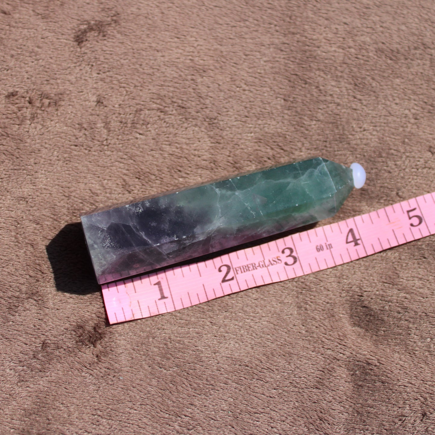 Rainbow Fluorite tower with natural colors and geometric shape for crystal enthusiasts