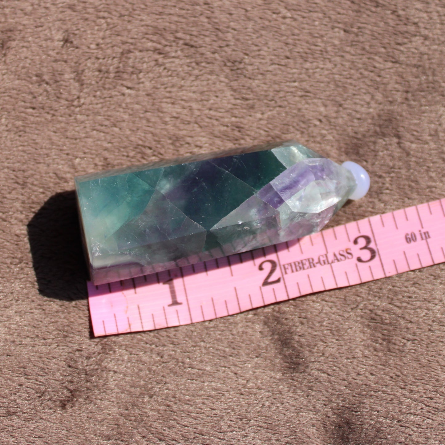 Rainbow Fluorite tower with vibrant colors, showcasing its unique geometric shape and natural beauty