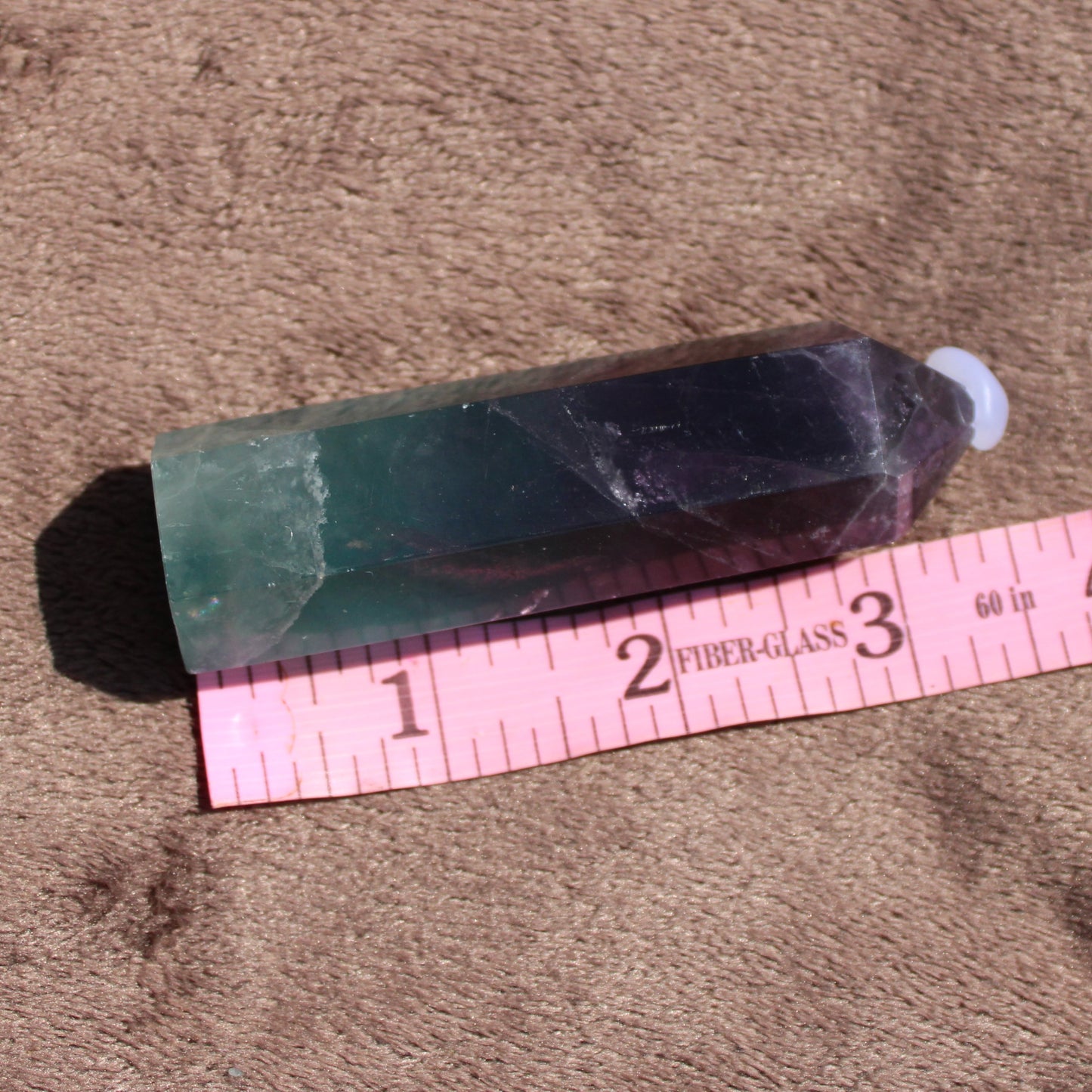 Rainbow Fluorite tower with a smooth finish, showcasing vibrant green and purple colors