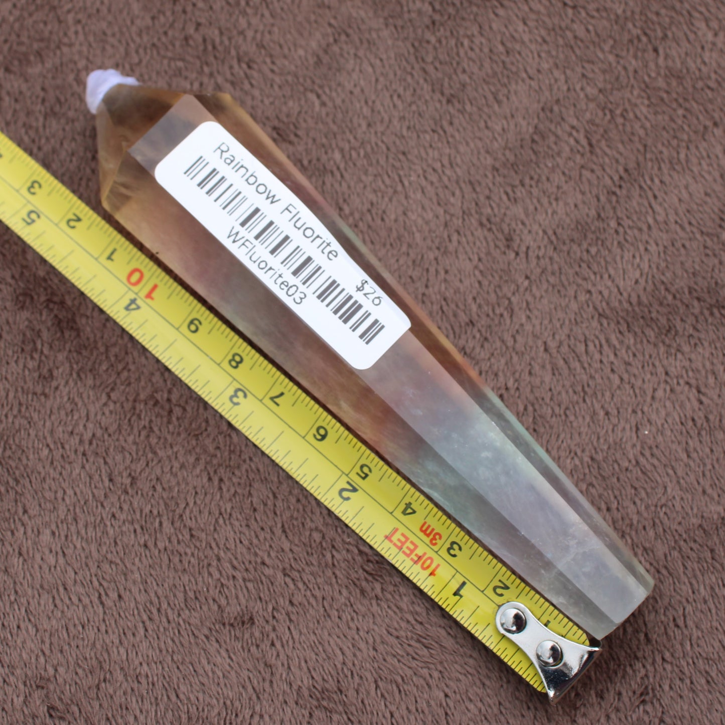 Rainbow Fluorite Wand crystal measuring about 4 inches with label from Different Branches LLC