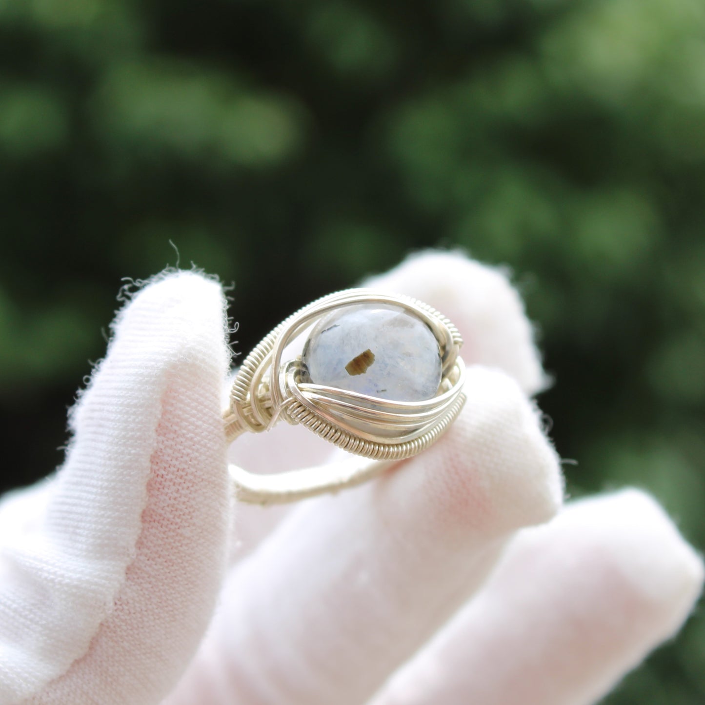 Handcrafted rainbow moonstone sterling silver ring with intricate wire wrapping for a unique jewelry piece