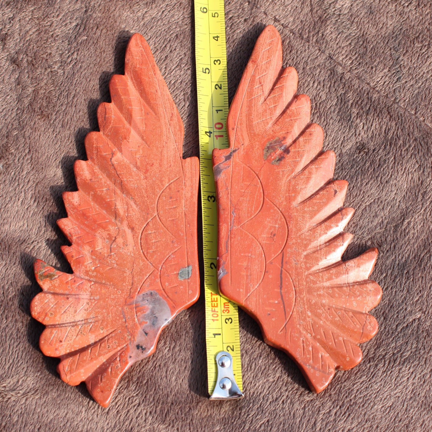 Red Jasper Owl Wings crystal pair carved with detailed feathers and natural stone patterns