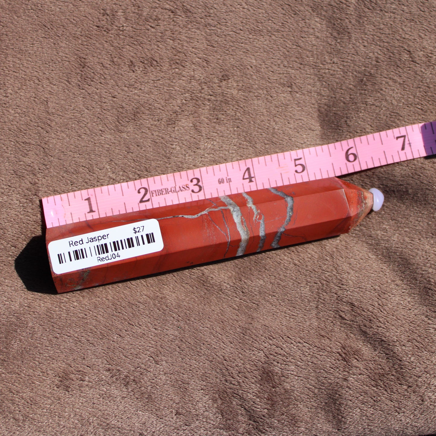 Red Jasper tower with unique patterns, measuring approximately 6 inches in length