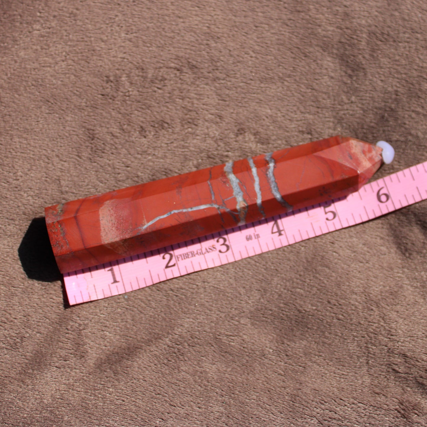 Red jasper tower with natural patterns, measuring approximately six inches long