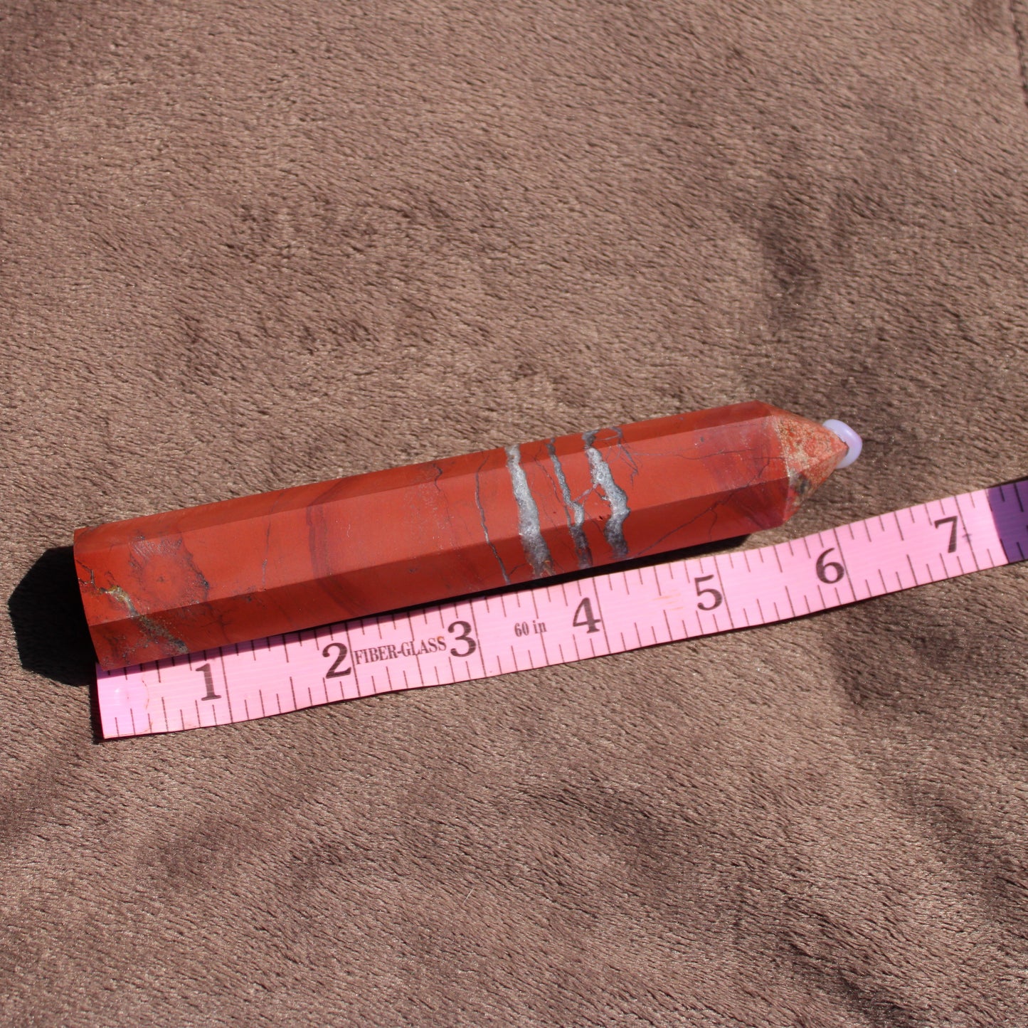 Natural red jasper tower with unique patterns, perfect for healing and decoration
