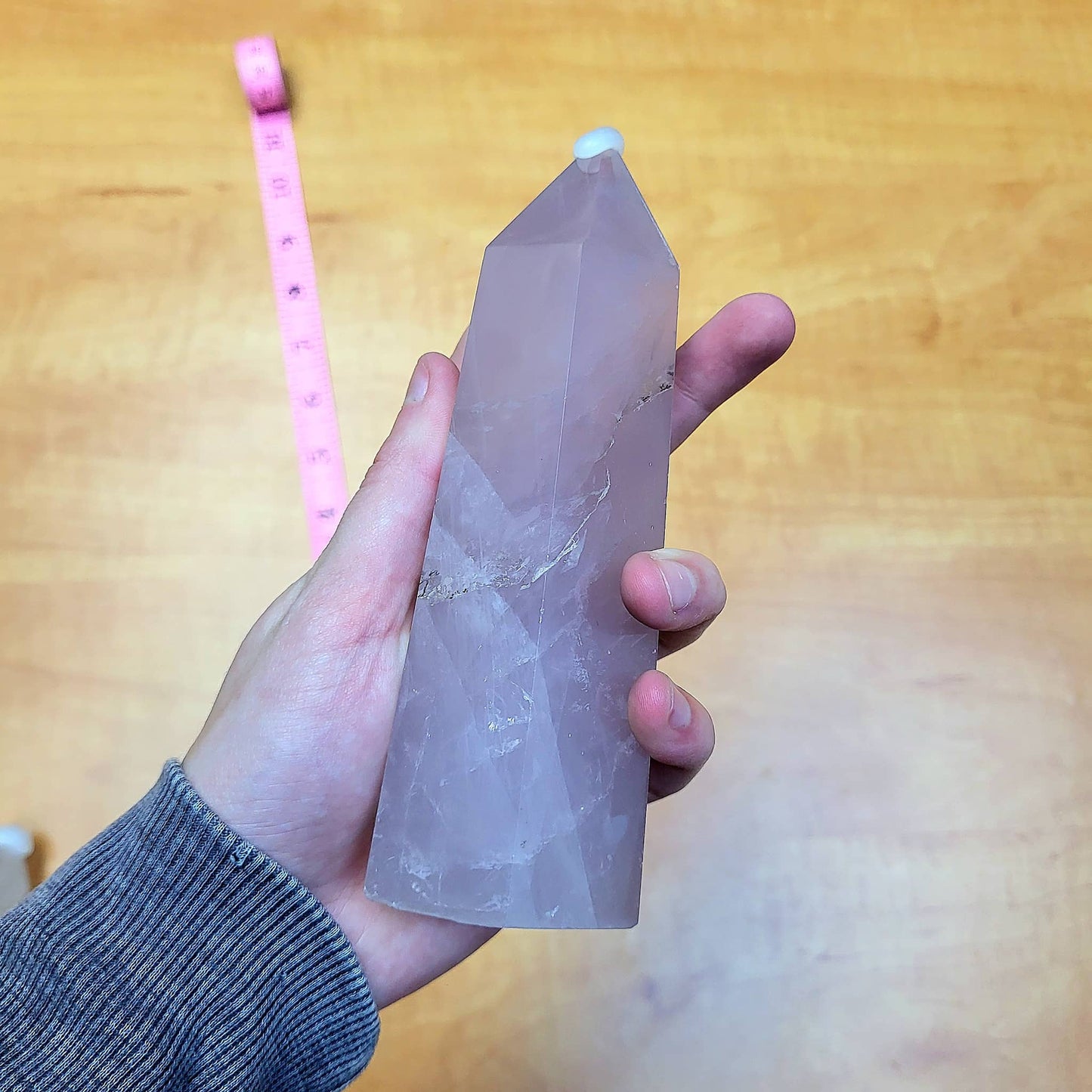 Hand holding a Rose Quartz Statement Tower with a smooth polished surface and unique facets