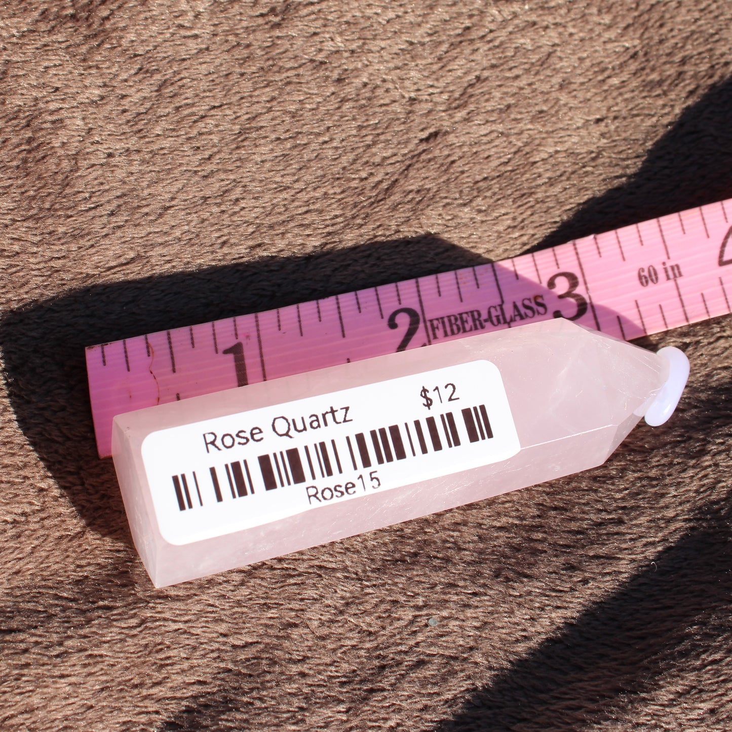 Natural Rose Quartz tower priced at twelve dollars, showcasing its soft pink color and smooth surface