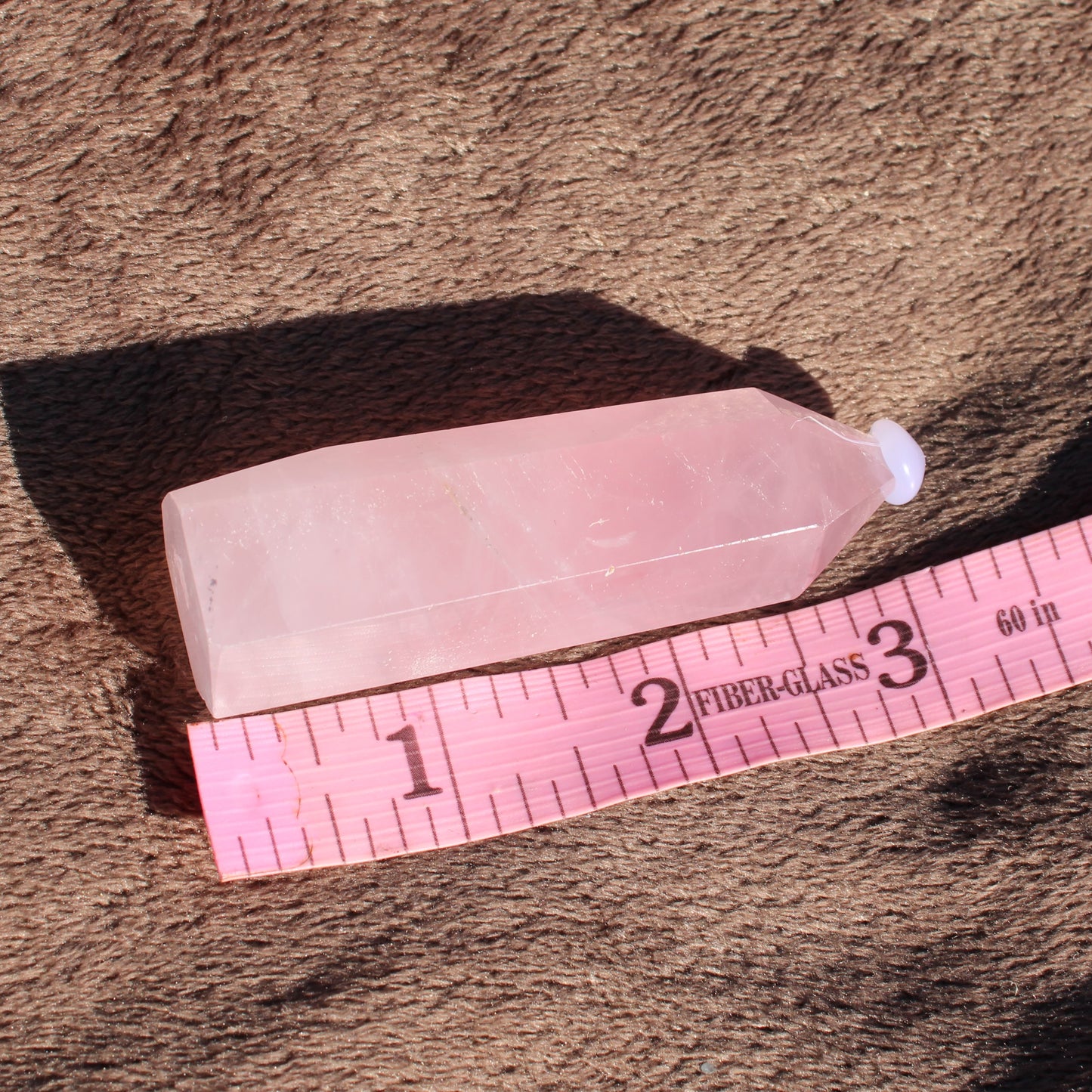 Rose Quartz tower showcasing its light pink hue and smooth facets, perfect for crystal healing