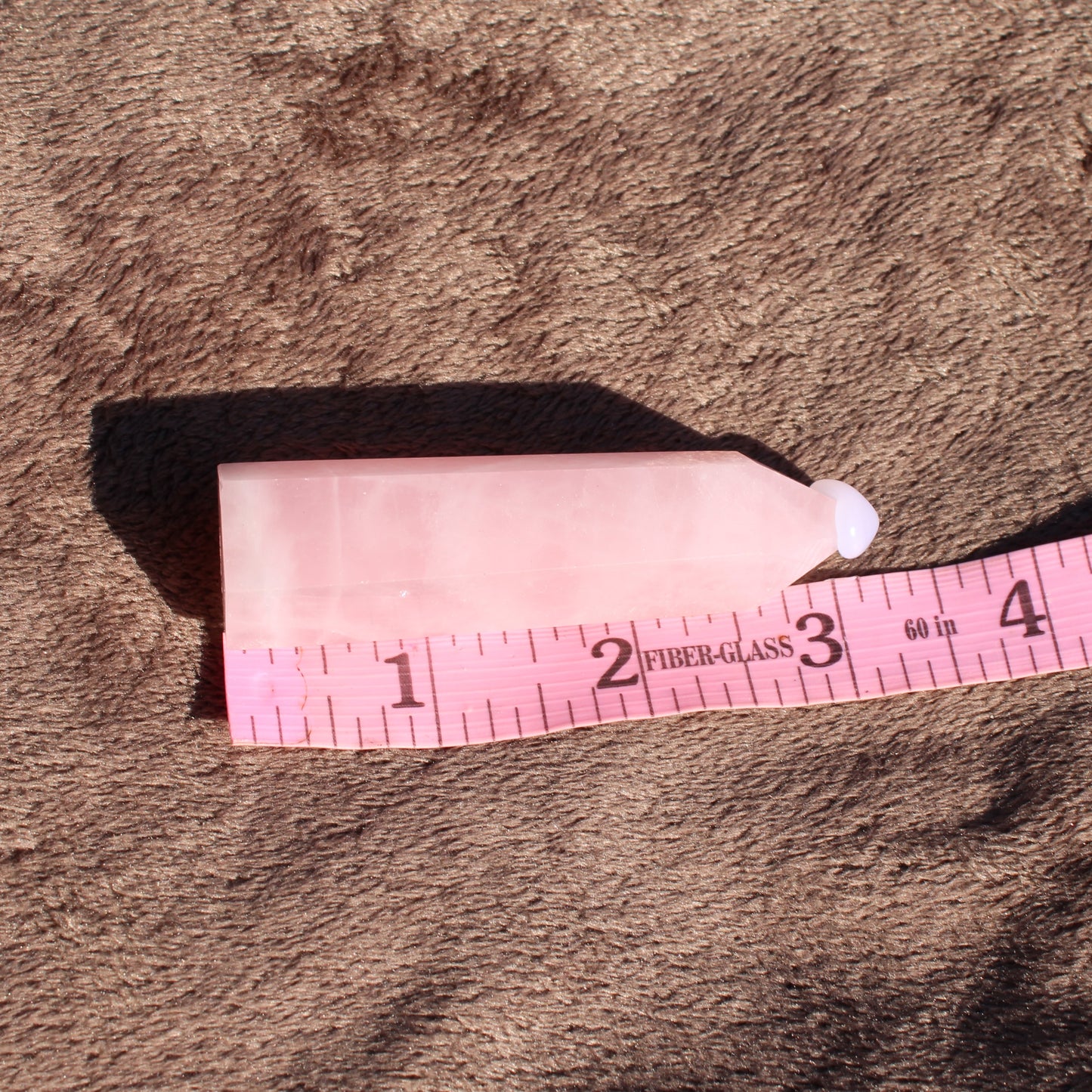 Natural Rose Quartz tower with smooth finish, ideal for crystal healing and decoration