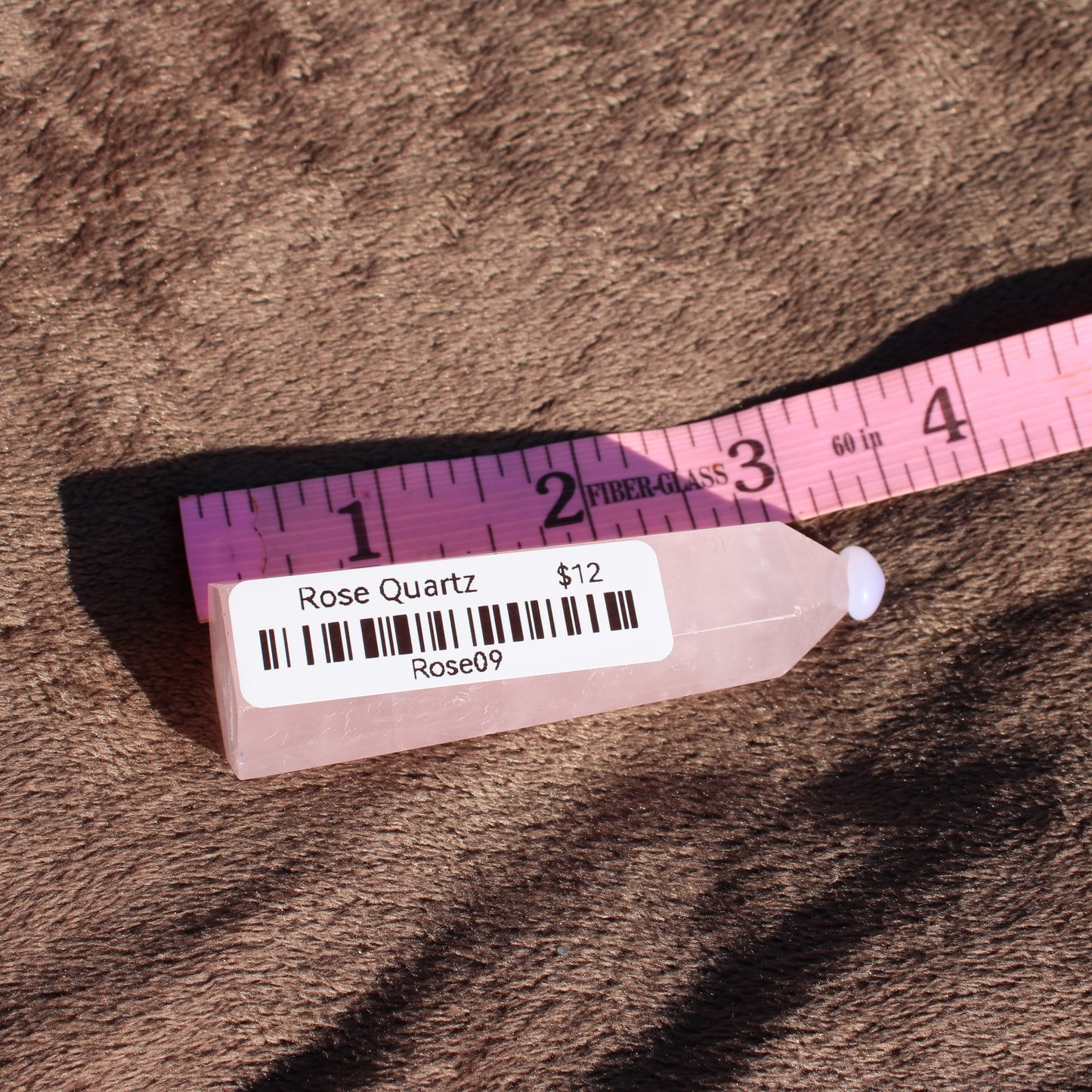 Rose Quartz tower with a smooth finish and price label from Different Branches LLC