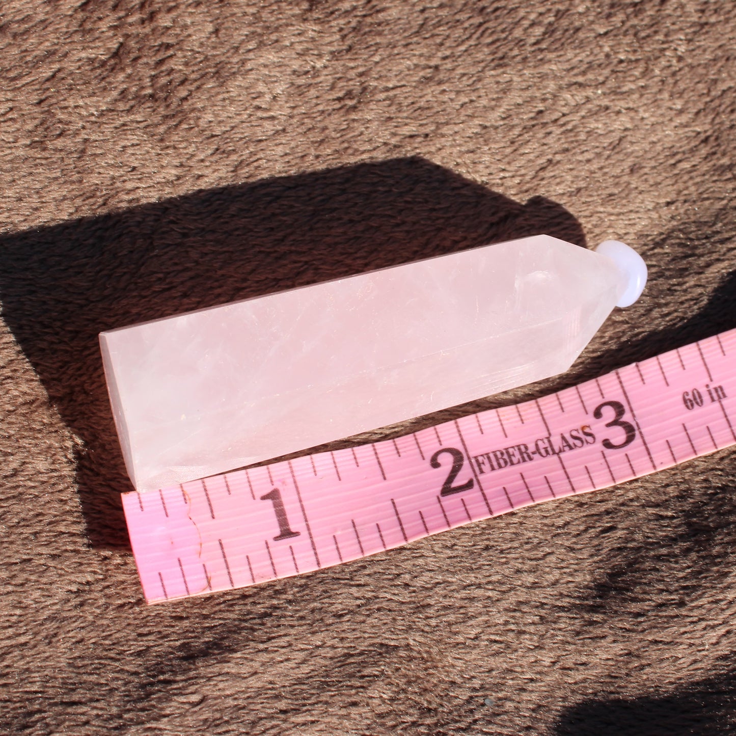 Rose Quartz tower from Different Branches LLC, showcasing its pink crystal hue and geometric shape