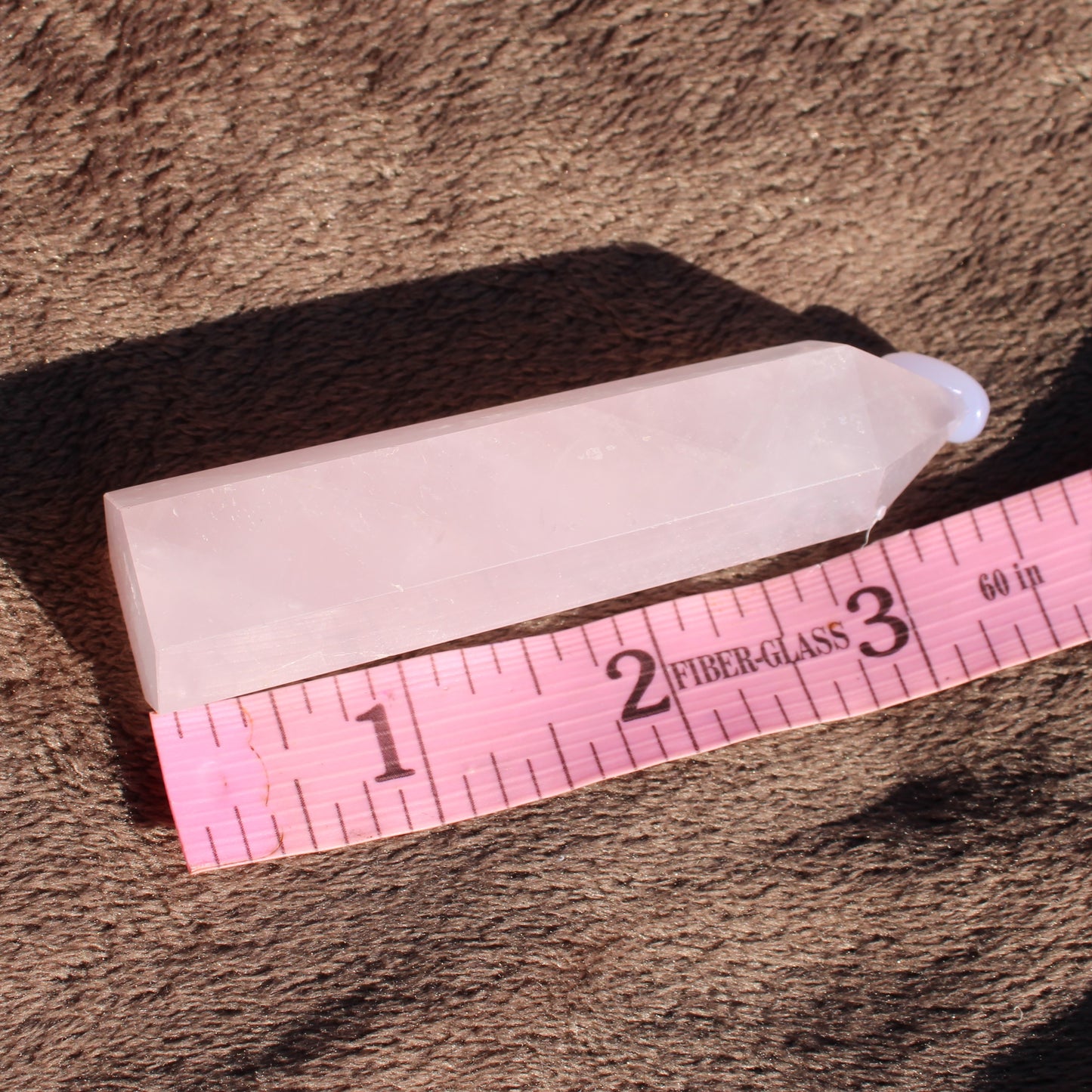 Rose Quartz tower with a polished surface, measuring approximately 2 inches in height, ideal for decor or healing