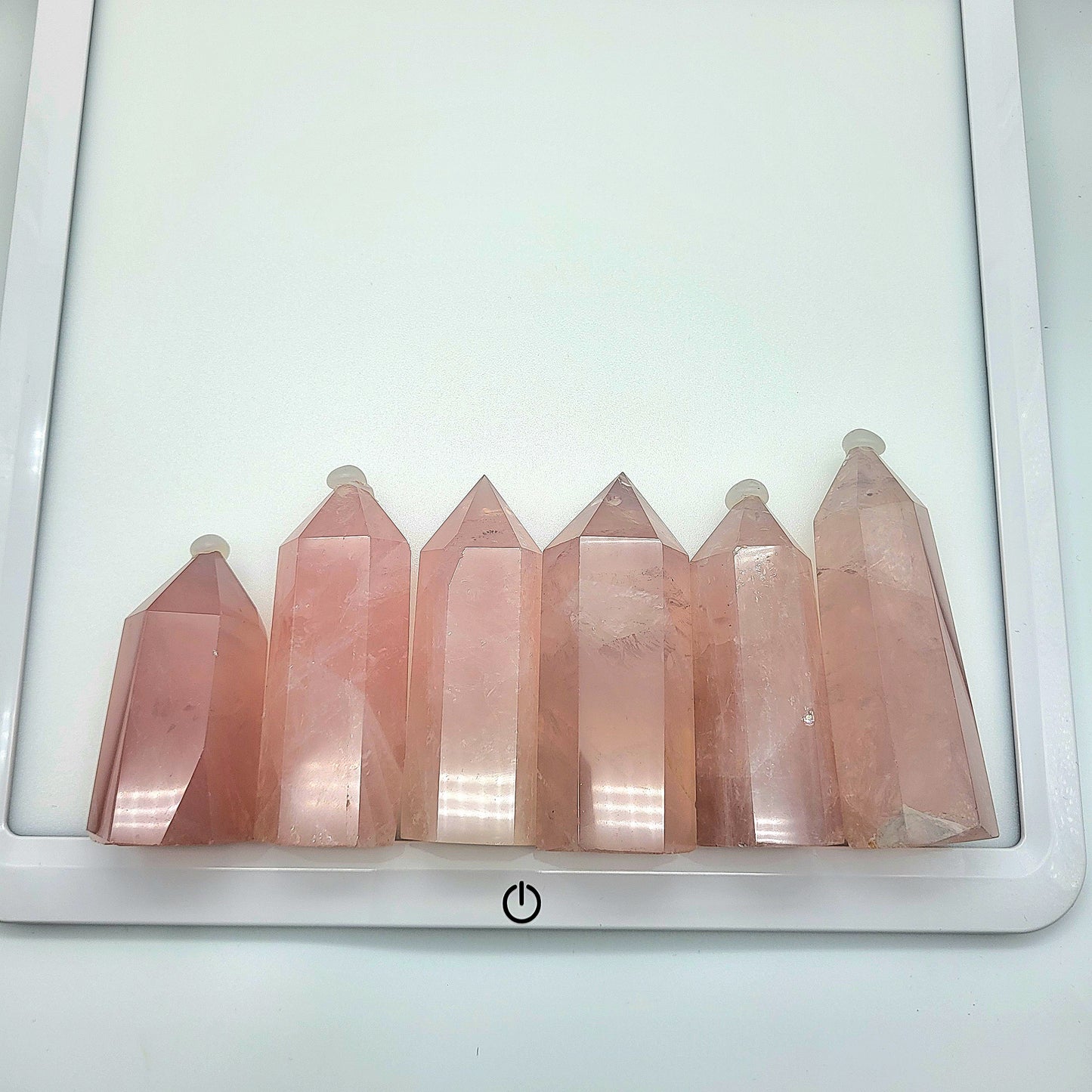 Set of six Rose Quartz Towers displaying their natural pink color and unique crystal structure