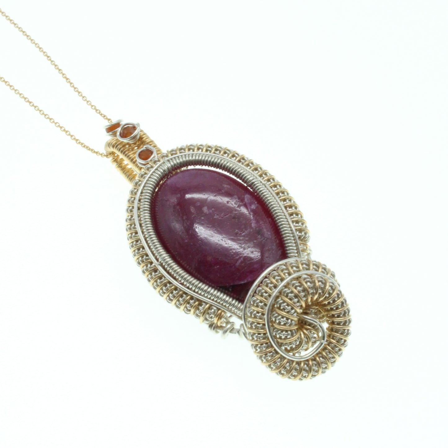 Elegant ruby pendant with garnet accents, featuring a unique wire design and attached chain