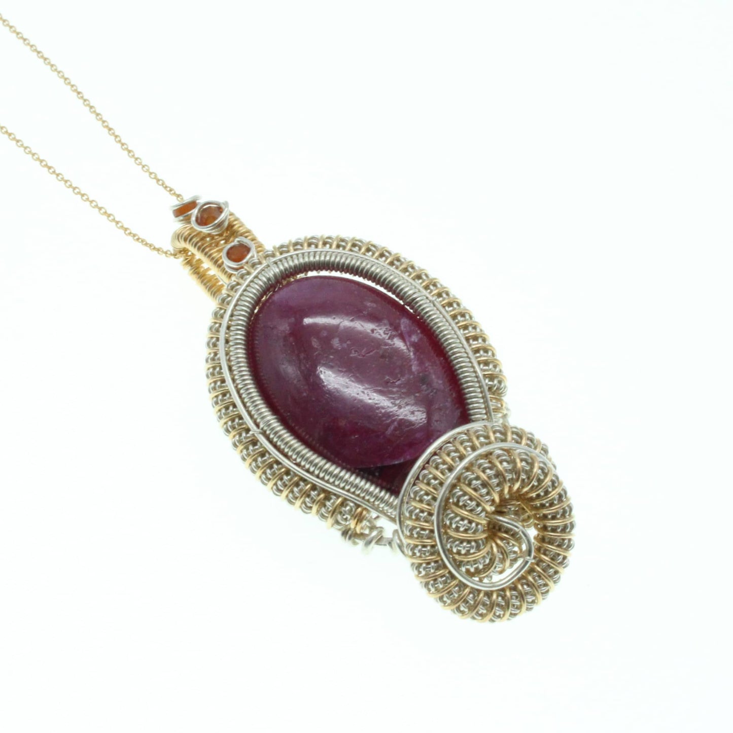 Elegant ruby pendant with garnet accents, featuring a unique wire design and attached chain