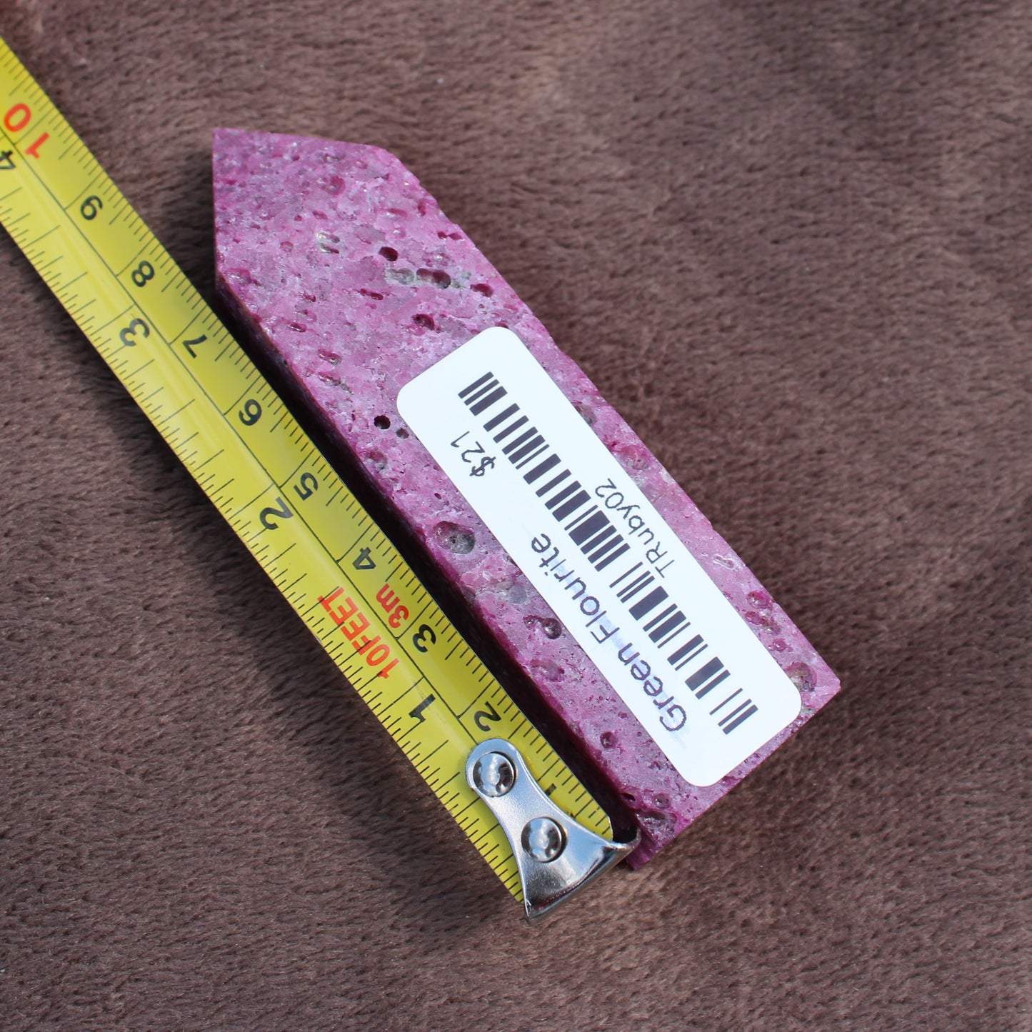 Ruby Tower crystal from Different Branches LLC shown next to measuring tape for size reference