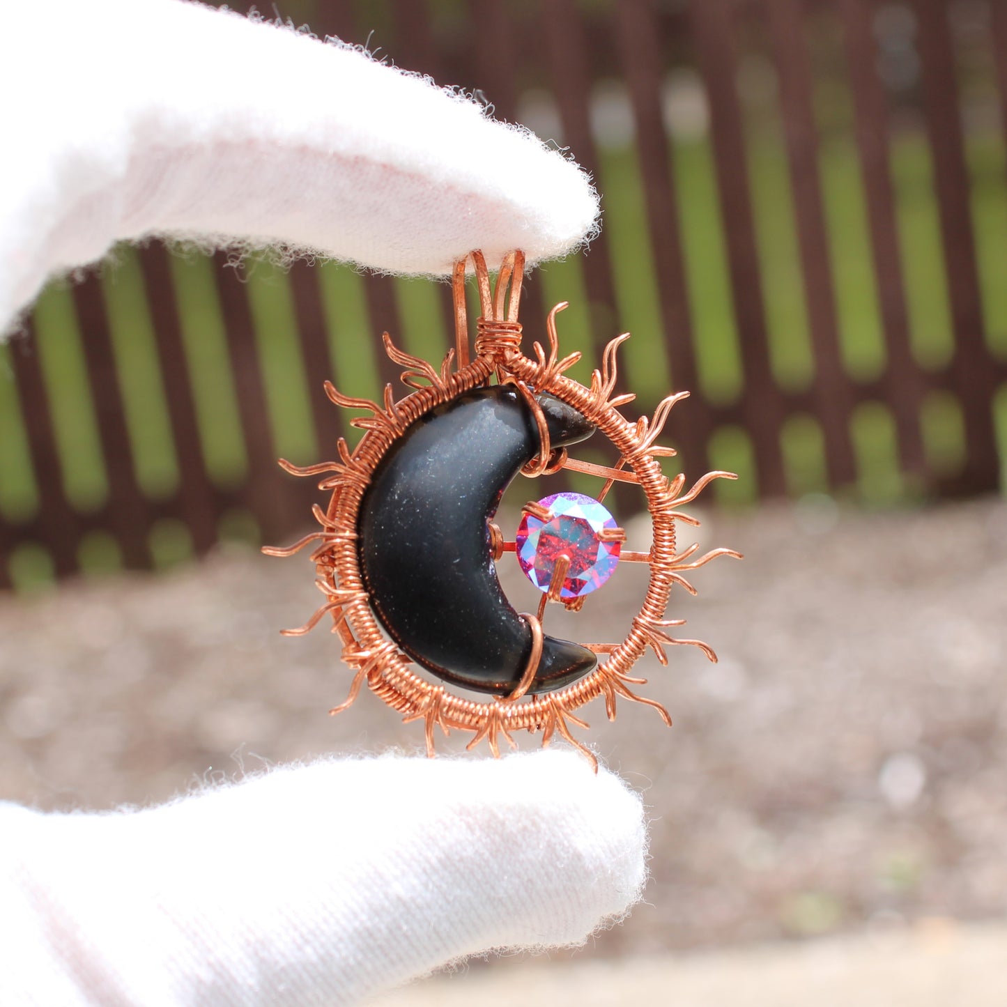 Handcrafted pendant from the Sun and moon copper collection featuring a black moon and colorful crystal