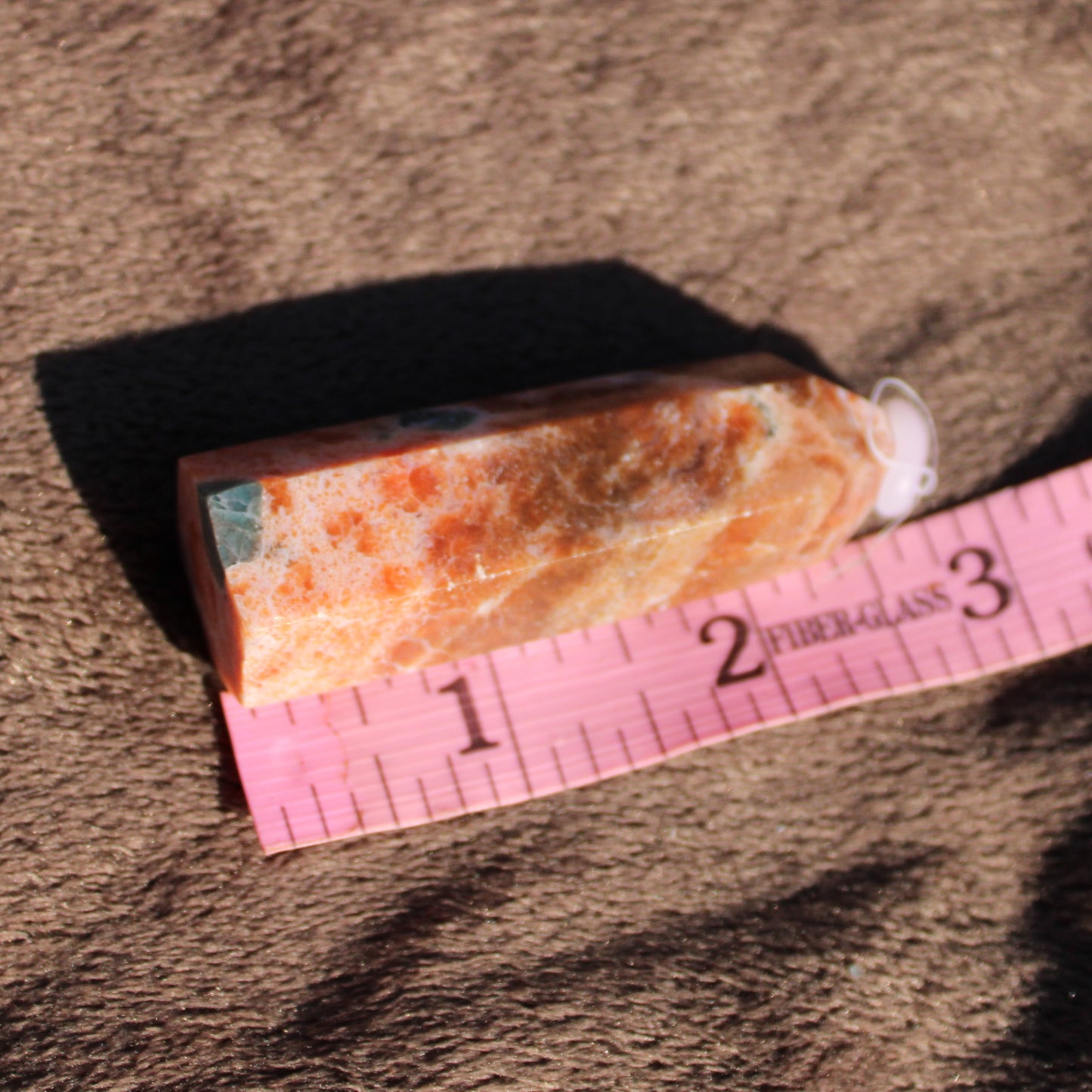 Natural Sunstone tower with a smooth finish, showcasing rich orange hues and crystal clarity