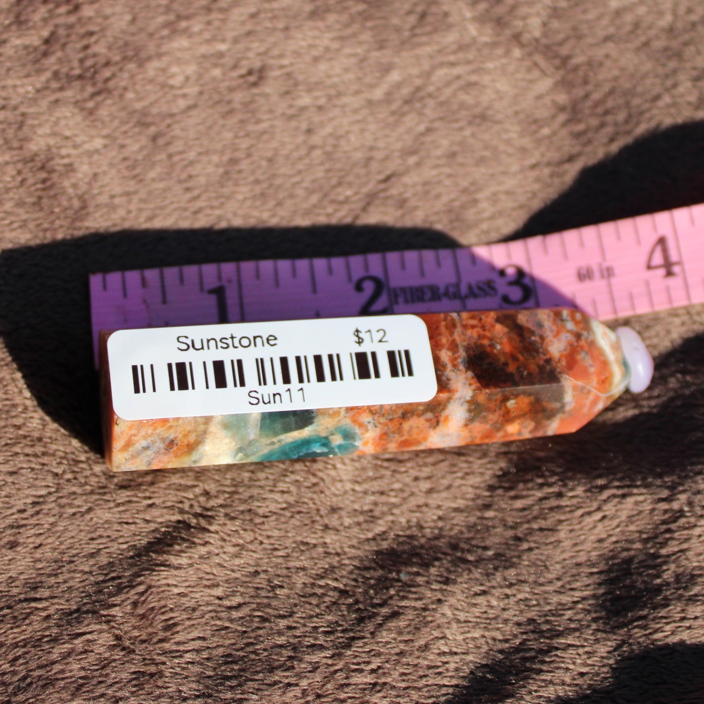 Unique Sunstone tower with vibrant colors and markings, perfect for crystal enthusiasts