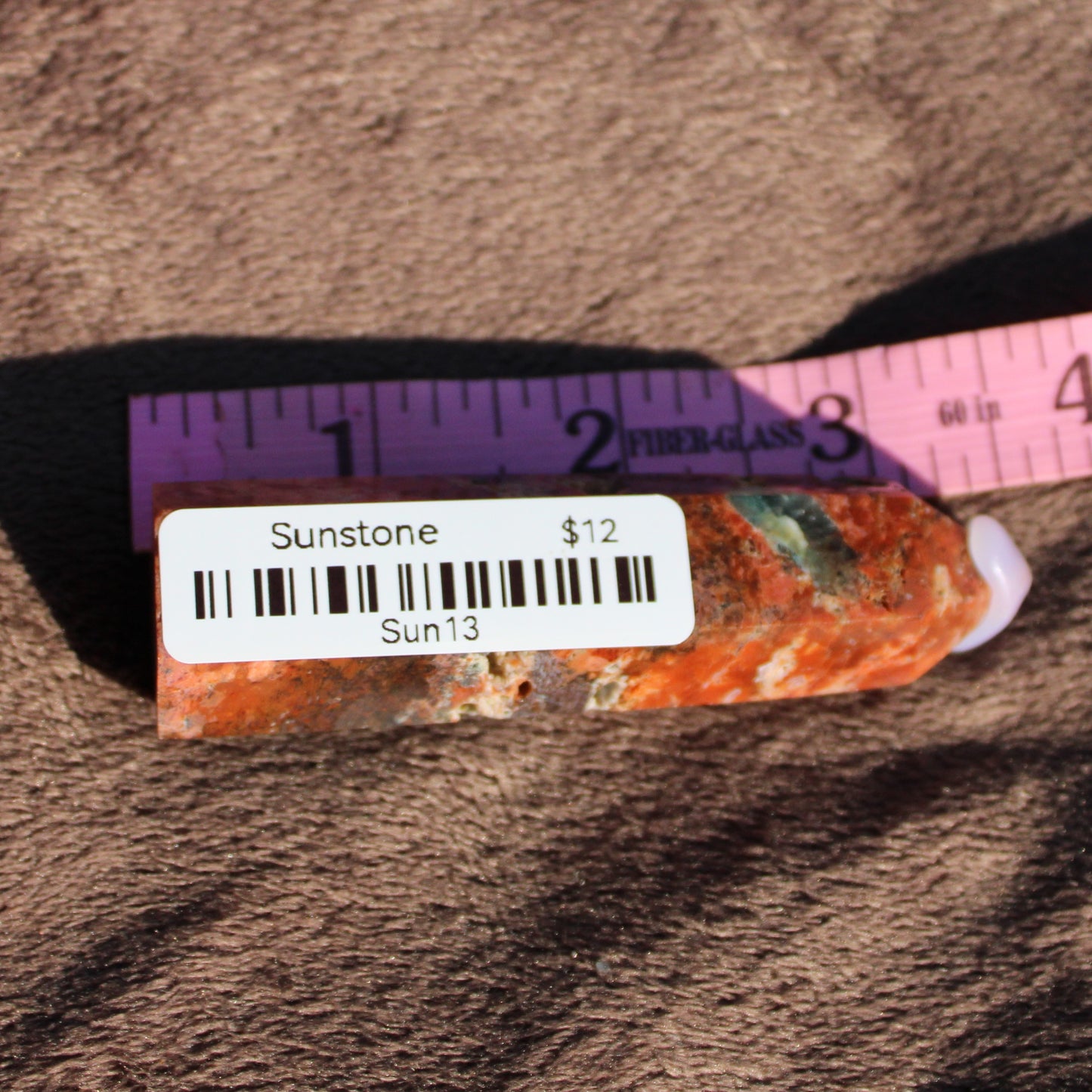Sunstone tower crystal with vibrant orange hues, priced at twelve dollars for healing and décor.