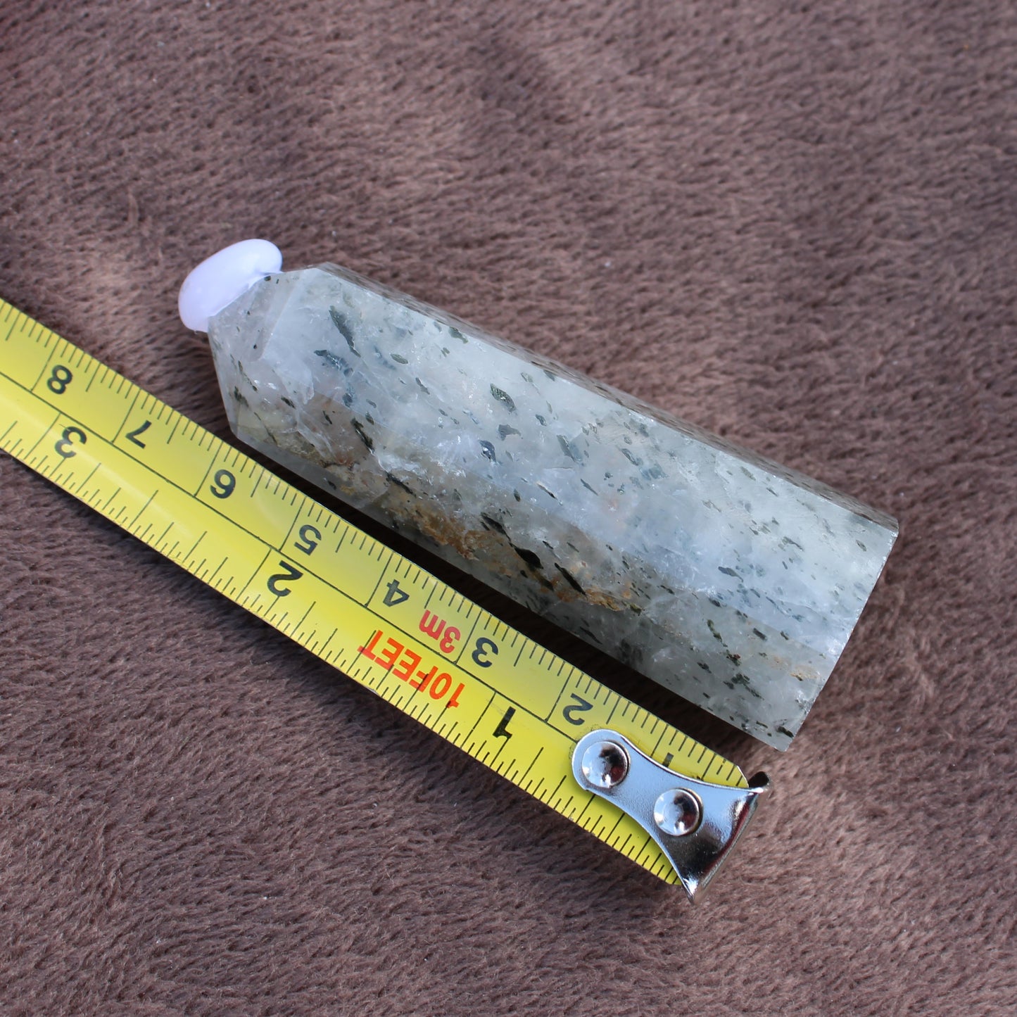 Tourmalited Quartz Tower crystal from Different Branches LLC shown next to measuring tape for size reference