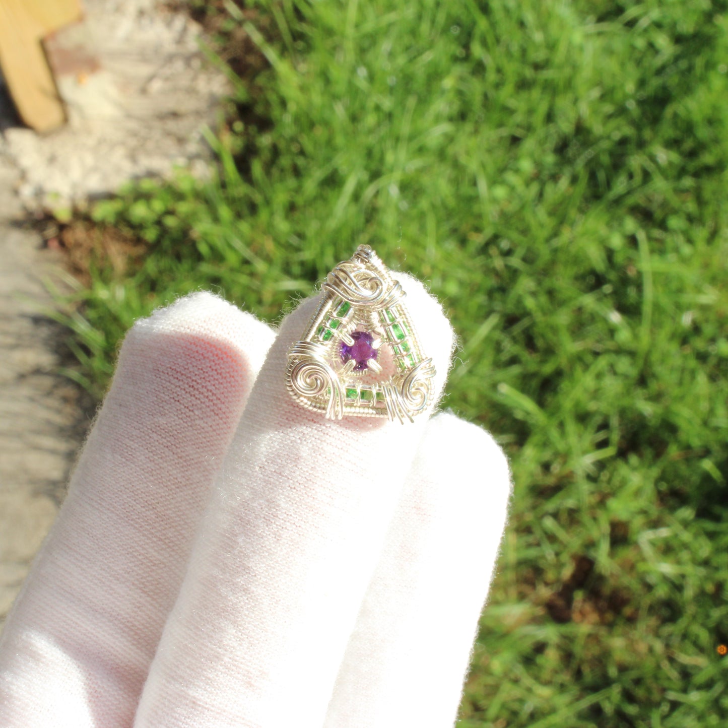 Wire-wrapped sterling silver ring featuring a Tsavorite and amethyst gemstone centerpiece